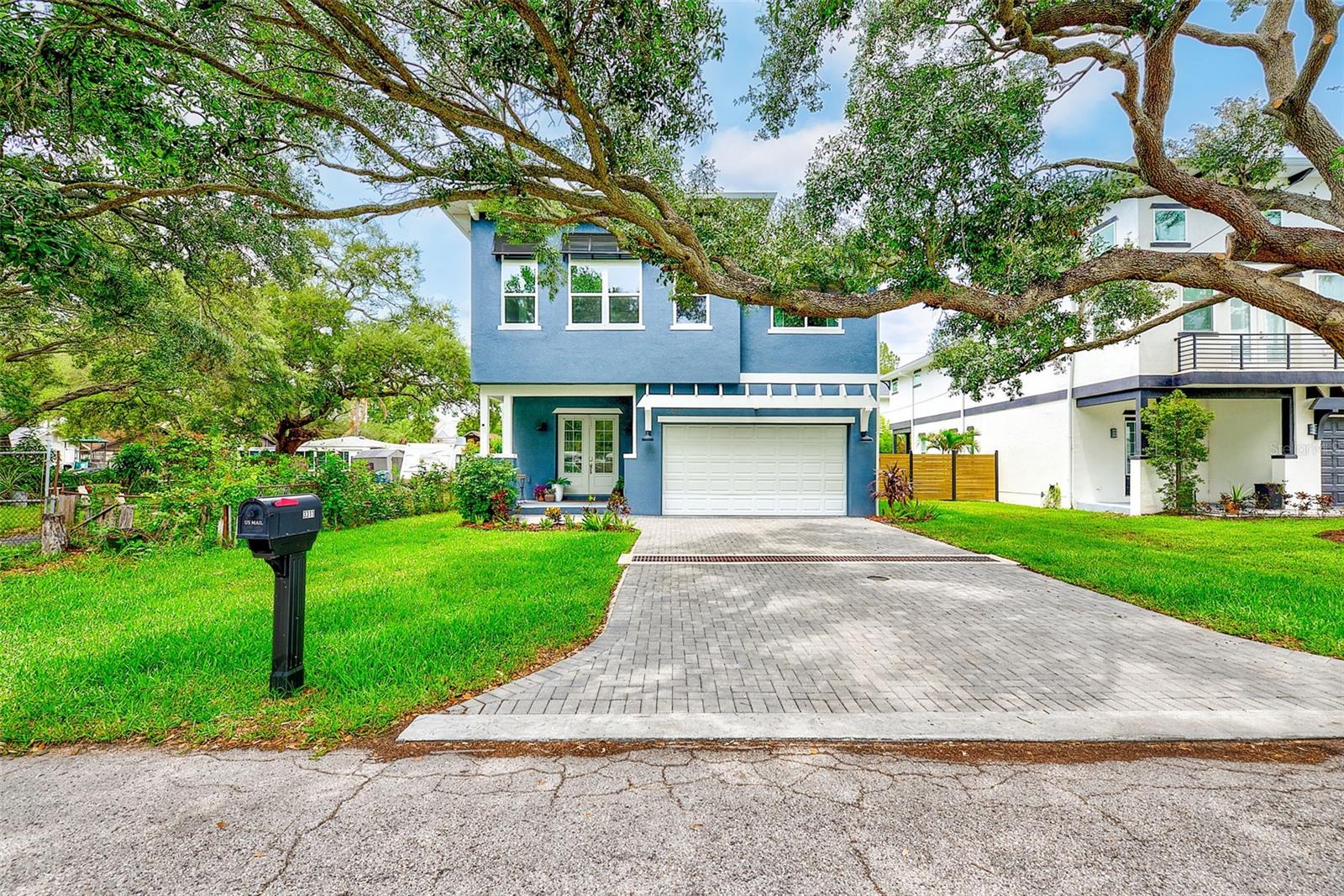 Located in the heart of Ballast Point, this beautifully designed Coastal Haven offers nearly 3,000 square feet of thoughtfully crafted living space with 5 bedrooms, 3 full bathrooms, and an oversized upstairs retreat. Blending timeless coastal architecture with modern functionality, this home delivers the space, finishes, and location today's South Tampa buyers are seeking.
The open-concept floor plan is anchored by a stunning chef's kitchen featuring quartz countertops, solid wood cabinetry, stainless steel appliances, a farmhouse sink, oversized walk-in pantry, and an expansive center island overlooking the dining and living areas. Rich hardwood flooring, soaring ceilings, custom trim work, and abundant natural light create an inviting atmosphere throughout the main living spaces.
The flexible floor plan includes a first-floor bedroom and full bathroom, ideal for guests, multigenerational living, or a private home office. Upstairs, an expansive retreat creates a true second living area and one of the home's most memorable spaces. Surrounded by oversized windows overlooking the canopy of mature oak trees, the room offers a unique treehouse-like ambiance rarely found in South Tampa. Elevated among the branches rather than overlooking neighboring rooftops, the space feels remarkably private and serene. A substantial custom-built entertainment and storage wall is currently being installed and will provide a stunning focal point while adding both beauty and functionality to this already impressive space.
The private primary suite serves as a true retreat with dual walk-in closets and a spa-inspired bath featuring dual vanities, a freestanding soaking tub, oversized walk-in shower with body sprays, and designer finishes. Three additional upstairs bedrooms, a full bathroom, and a convenient laundry room complete the second level.
The current owners have further enhanced the home with custom woven window treatments throughout and a premium hybrid turf installation in the side and rear yards, combining luxury-grade artificial turf with natural grass accents for beauty, durability, and low-maintenance outdoor living. A covered lanai and private backyard provide the perfect setting for entertaining, relaxing, or enjoying Florida's year-round lifestyle.
Situated beneath a canopy of mature oaks in one of South Tampa's most desirable neighborhoods, this home is just minutes from Ballast Point Park, Bayshore Boulevard, MacDill Air Force Base, Downtown Tampa, Tampa General Hospital, shopping, dining, and Tampa International Airport. Located in Flood Zone X with no flood insurance required, this exceptional residence offers the perfect combination of luxury, convenience, and location.