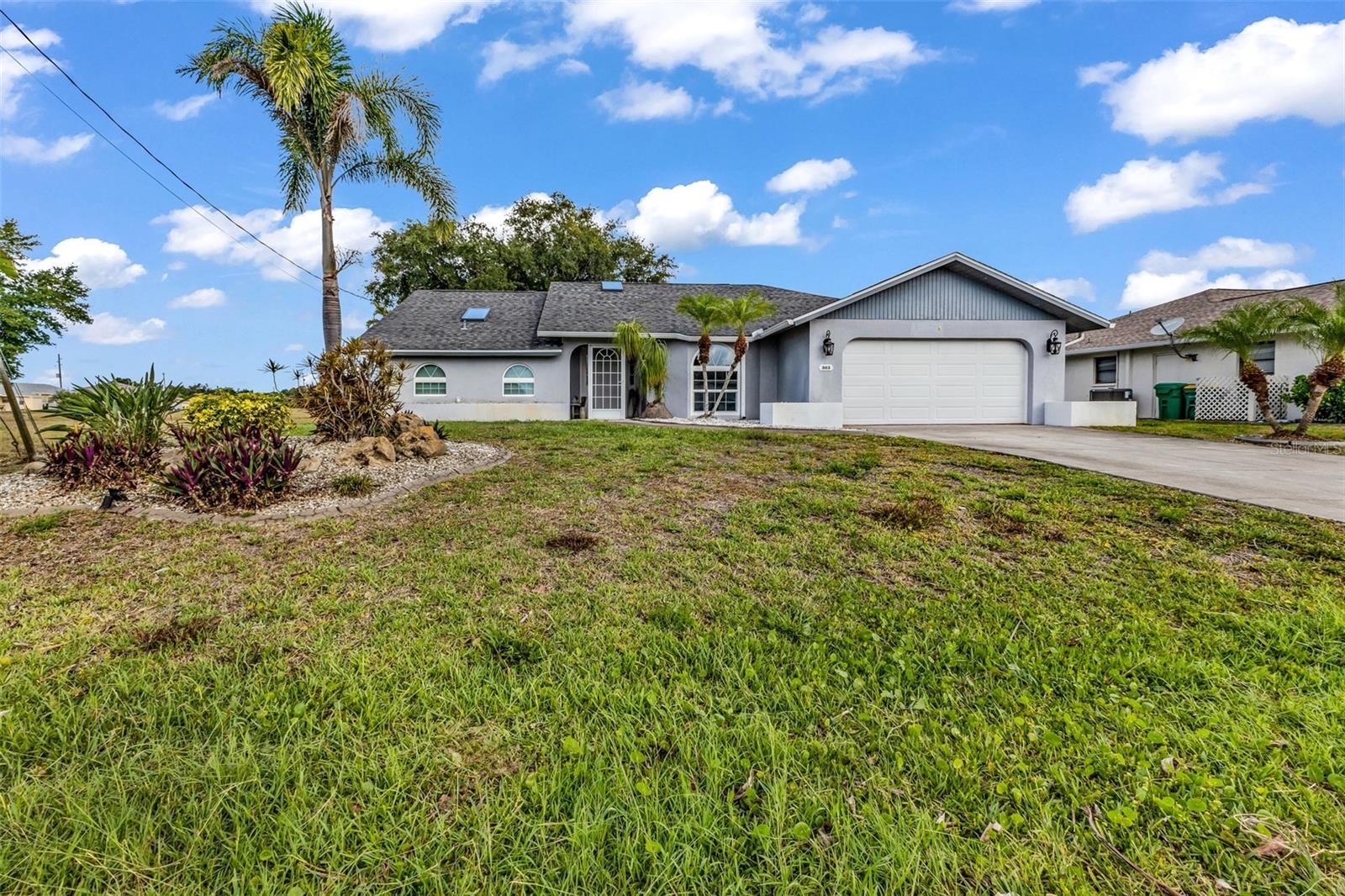 Located in the highly desirable community of Rotonda West, this beautifully maintained FURNISHED 3-bedroom, 2-bath home with a 2-car garage offers 2,045 square feet under air and picturesque canal views-perfect as a primary residence, seasonal retreat or investment property. Designed for comfortable Florida living, this home features porcelain and ceramic tile flooring throughout along with a spacious, functional layout. The formal living room showcases French doors leading to the lanai and flows seamlessly into the dining room, creating an ideal setting for entertaining guests. The inviting family room is highlighted by a stunning wood plank ceiling and skylights that fill the space with natural light. The kitchen is equipped with stainless steel appliances, granite countertops, tile backsplash, breakfast bar and a cabinet pantry. The spacious primary suite offers a walk-in closet and French doors providing direct access to the lanai. The ensuite bathroom features dual sinks, a relaxing garden tub, a tiled steam walk-in shower, and a linen closet. Both guest bedrooms also include walk-in closets, offering ample storage and comfort for family or visitors. The guest bathroom includes a single vanity and walk-in shower. Enjoy exceptional outdoor living on the expansive 28x33 extended paver lanai, complete with an outdoor kitchen and jacuzzi overlooking the water. For piece of mind the lanai features accordion shutters. Beyond the lanai, a separate paver sitting area with a firepit creates the perfect setting for relaxing evenings outdoors. The private 12x8 dock is ideal for fishing or enjoying breathtaking sunset views. Washer and dryer are conveniently located in the garage. Recent updates provide peace of mind: Hot Water Heater (2025), Impact Windows (2020), Boat Dock (2019), Roof & Impact Garage Door (2018), and AC (2017). Enjoy the peaceful setting and convenient location close to golf courses, beaches, dining, and shopping that make Rotonda West one of Southwest Florida’s most sought-after communities. Ask to see this one first...make YOUR appointment today!!!
