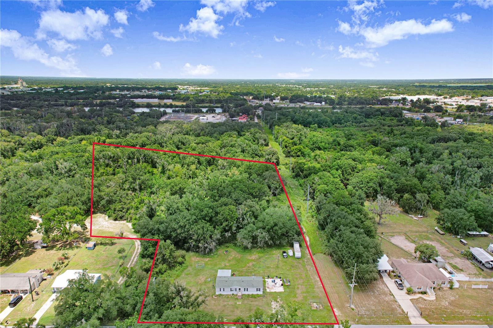 If you’ve been searching for that perfect blend of wide-open space and modern interior comfort, this is the one. Set on over five sprawling acres, this four-bedroom, two-bathroom home offers a rare sense of freedom and a connection to the outdoors that’s hard to find. The property stretches all the way back to a winding creek, providing a serene backdrop for your morning coffee or evening wind-down.

Inside, the heart of the home has been thoughtfully upgraded with quality finishes that defy the standard. The kitchen is a standout, featuring solid wood cabinetry and sleek stone countertops that create plenty of prep space for the home chef. The open layout flows naturally, making it easy to transition from meal prep to relaxation.

Step outside onto the expansive covered deck—a true extension of the living space. It’s the ideal spot for al fresco dining or simply taking in the views of your massive backyard. With four bedrooms, there is plenty of room to craft a dedicated home office, a hobby studio, or a guest retreat. This is more than just a house; it’s a private escape with room to breathe, all while keeping those high-end touches you love.
