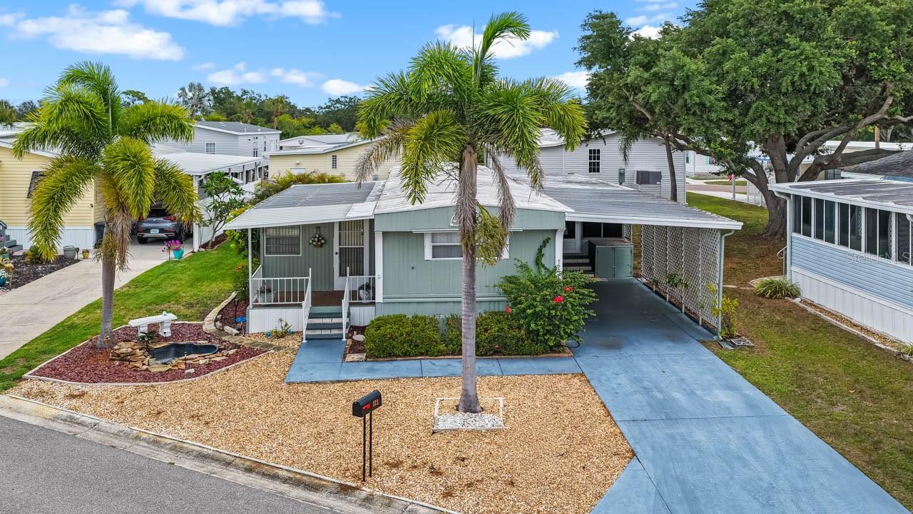 ARE YOU SEARCHING FOR AN AFFORDABLE RETIREMENT OR SEASONAL HOME?  You really must check out this chance to acquire an ownership share in Caribbean Isles Residential Cooperative - one of Florida’s most desirable 55+ resident-owned waterfront communities. Here you will find the lifestyle as appealing as the homes themselves. You will pay NO LOT RENT or CDD. This fully FURNISHED, and move-in ready, residence offers an open concept layout with two bedrooms, two bathrooms, a formal living room, an eat-in kitchen, and a versatile family room which can be utilized as a third bedroom. The kitchen is fully accessorized and includes everything you need to begin enjoying your new home immediately.  The primary bedroom features a large built-in closet and a private ensuite bath. Carpeted areas are Berber, known for durability and long wear, while the kitchen and bathrooms feature laminate flooring. An enclosed lanai provides the perfect spot for morning coffee, a good book, or simply enjoying peaceful Florida relaxation. Caribbean Isles is also known for its vibrant lifestyle. Residents enjoy outdoor activities, a heated pool, themed parties, game nights, dinners, and live entertainment —all centered around a clubhouse that includes a well-stocked library, craft room, and game room. It is truly a community where neighbors become friends, and every week offers something to look forward to.  Caribbean Isles is located midway between Tampa/St. Petersburg and Sarasota/Bradenton on Florida’s West Coast — close to beaches, restaurants, shopping, and medical facilities. Bring your boat or RV — the community also offers on-site storage for a nominal annual fee of $120 to $250, depending on space size. If you’re seeking a place where you can simplify, socialize, and truly live — this is the opportunity you’ve been waiting for. Just pack a suitcase, and don't forget your swimsuit.