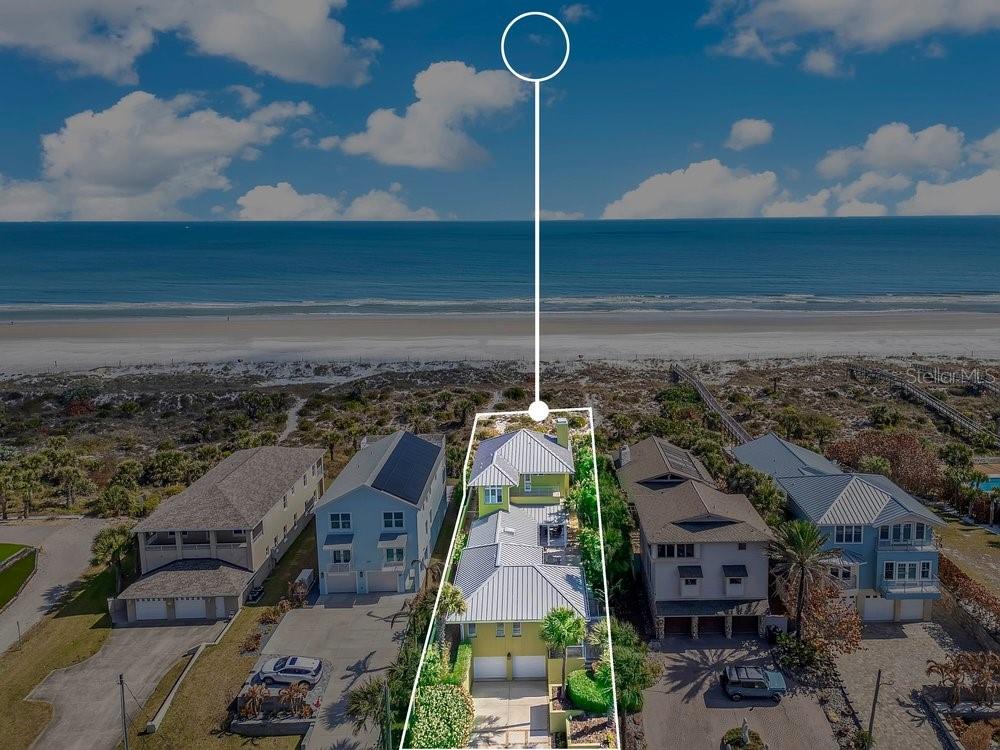 Welcome to your meticulously cared-for beachfront escape in New Smyrna Beach, where the soundtrack is rolling waves and every day feels like Margaritaville. Built for coastal living with solid block construction, impact windows and doors, and a metal roof installed in 2023, this oceanfront estate pairs peace of mind with pure paradise. Step outside to your resort-style outdoor retreat featuring a pool, spa, and a summer kitchen complete with a brand-new grill perfect for sunset dinners, weekend gatherings, and barefoot beach days that never have to end. Inside, the home shines with solid wood floors, wood cabinetry, stainless steel appliances, and a fully equipped kitchen anchored by a gas range made for everything from fresh caught seafood to chef inspired dishes. The primary suite is a showstopper: wall-to-wall French doors framing breathtaking ocean views, plus a private balcony where you can take it all in salt air, sea breeze, and the sound of the surf. The updated, spa-like bath delivers vacation vibes daily with a stand-alone tub, walk-in shower, and abundant closet space. Need space for guests or multi-generational living? An attached guest house offers two bedrooms and a separate family room ideal for visitors, a private retreat, or flexible living. On the lower level, you will find a two-car garage, wine room, storage room, and a large driveway featuring room for all your beach gear and then some. Just a short distance to the shops, dining, and energy of famous Flagler Avenue and with golf cart friendly New Smyrna Beach at your doorstep this is the dream of oceanfront living. Relax, listen to the ocean, and make this beachfront home your own. Be sure to click on the virtual tour links.