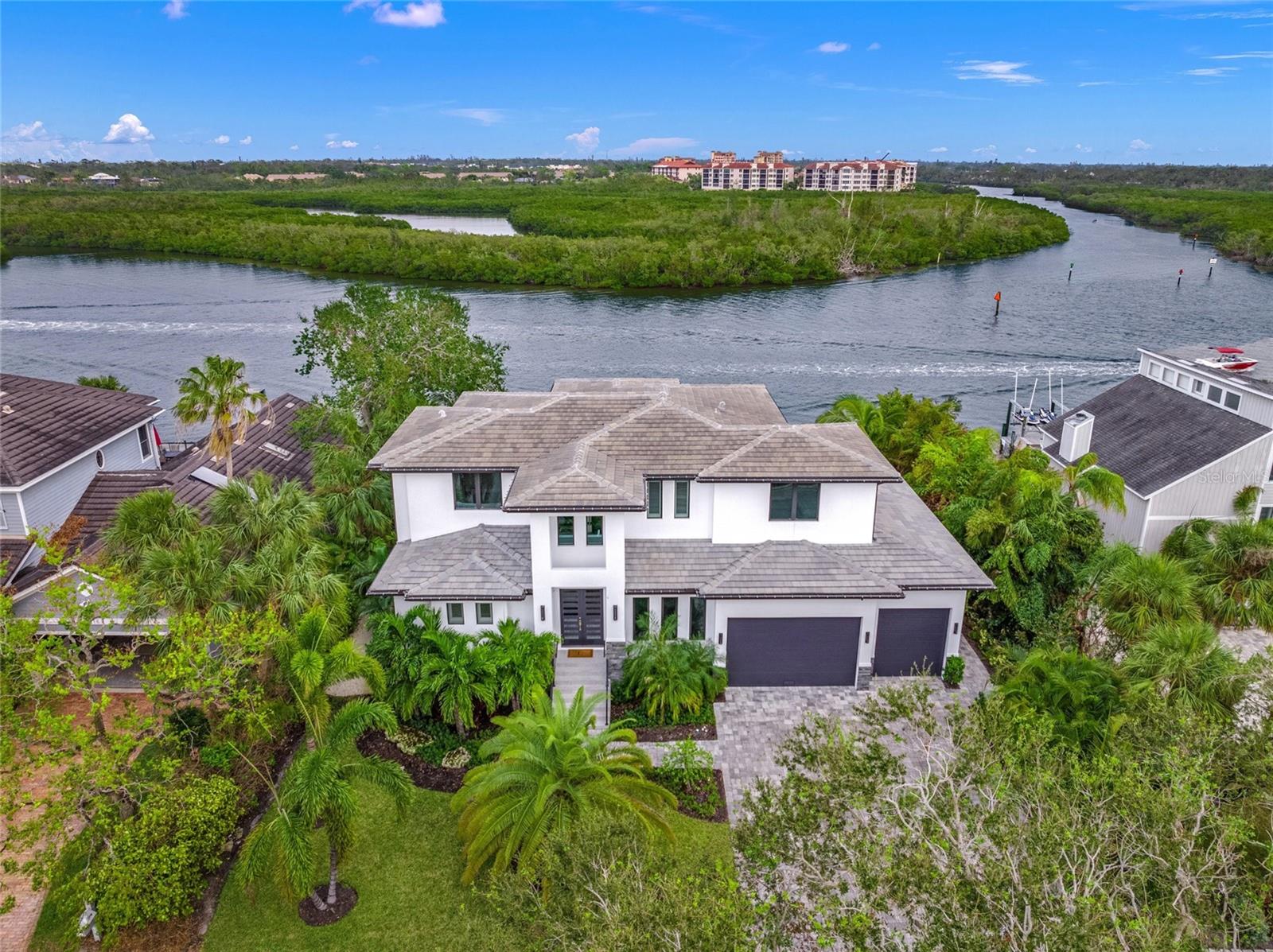 Experience the pinnacle of luxurious waterfront living, where your dreams of boating, entertaining, and relaxation converge in unparalleled splendor. This exquisite elevated custom-built estate on Siesta Key redefines elegance, had NO flood damage, offering sweeping, private vistas of the vibrant intracoastal waterway and showcasing masterful design at every turn.

Spanning two levels of opulent living space, this five-bedroom residence is thoughtfully equipped with an elevator for seamless convenience. Every corner is a testament to refined craftsmanship and attention to detail, featuring wide plank porcelain tile, 8-foot PGT insulated impact doors, a striking electric fireplace, and immersive surround sound that sets the mood for every occasion.

The main level invites effortless entertaining with its expansive living area, complete with a sophisticated wet bar featuring a wine cooler, ice maker, and direct access to the lanai. A spacious den provides a versatile retreat for work or leisure. Upstairs, the family room opens to an oversized balcony, presenting mesmerizing sunrises and panoramic views of the downtown Sarasota skyline.

Culinary enthusiasts will delight in the gourmet kitchen, a chef’s paradise outfitted with state-of-the-art Dacor appliances, double ovens, and sleek quartz waterfall countertops. For alfresco dining, the outdoor kitchen becomes the ultimate stage for creating memorable meals under the stars.

The outdoor living space rivals the finest resorts, with a sparkling pool and spa surrounded by a travertine lanai and deck. Beyond, a newly constructed dock and boat lift await, ensuring your vessel is always ready for adventures on the water.

At day’s end, retreat to the indulgent master suite, a haven of tranquility featuring a spa-like en-suite bath that evokes the ambiance of a five-star resort. Car enthusiasts will appreciate the oversized three-car garage, designed with ample height to accommodate car lifts, perfect for housing your prized collection.

Nestled within one of Siesta Key’s most prestigious communities, this home offers peace of mind with a newly installed generator and the ultimate convenience of proximity to the beach, dining, and shopping—just moments away.

This is not just a home; it’s a lifestyle of unparalleled luxury and elegance, designed for those who desire only the best. Welcome to your paradise.