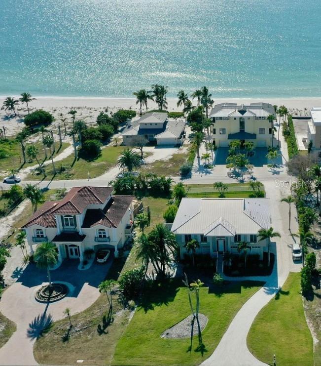 Outstanding opportunity to own an elevated pool home with beautiful views of the sparkling Gulf of Mexico on the highly sought-after north end of Longboat Key. This 3-bedroom, 2.5-bath Key West–style residence is ideally positioned on an oversized 19,400-sq.-ft. lot that stretches from Gulf of Mexico Drive to Gulfside Road—just steps from a pristine, uncrowded stretch of sandy coastline.

Built in 2001, this custom home offers a bright, open floor plan with spacious rooms, high ceilings, abundant windows, and quality finishes throughout. A private elevator or stairs lead from the expansive covered entertaining area by the pool to the main living level. The light-filled all-white kitchen features a gas cooktop, double ovens, and both a peninsula and breakfast area with Gulf views. Light wood floors flow into the inviting living room, where sliders open to a covered lanai—the perfect spot to enjoy sea breezes, sunsets, or a quiet read.

A formal dining room adds to the home’s easy entertaining flow. The peaceful primary suite with large ensuite bath also opens to the lanai, while the split-plan layout ensures privacy for guests. Outside, lush landscaping surrounds the sparkling pool, creating an idyllic island retreat.

Experience laid-back coastal living just minutes from the new St. Regis Resort, St. Armands Circle, and the cultural attractions of downtown Sarasota. Featured on the Longboat Key Garden Club’s 2005 Home and Garden Tour, this exceptional property blends quality, style, and casual elegance—a rare find on Longboat Key’s serene north end.