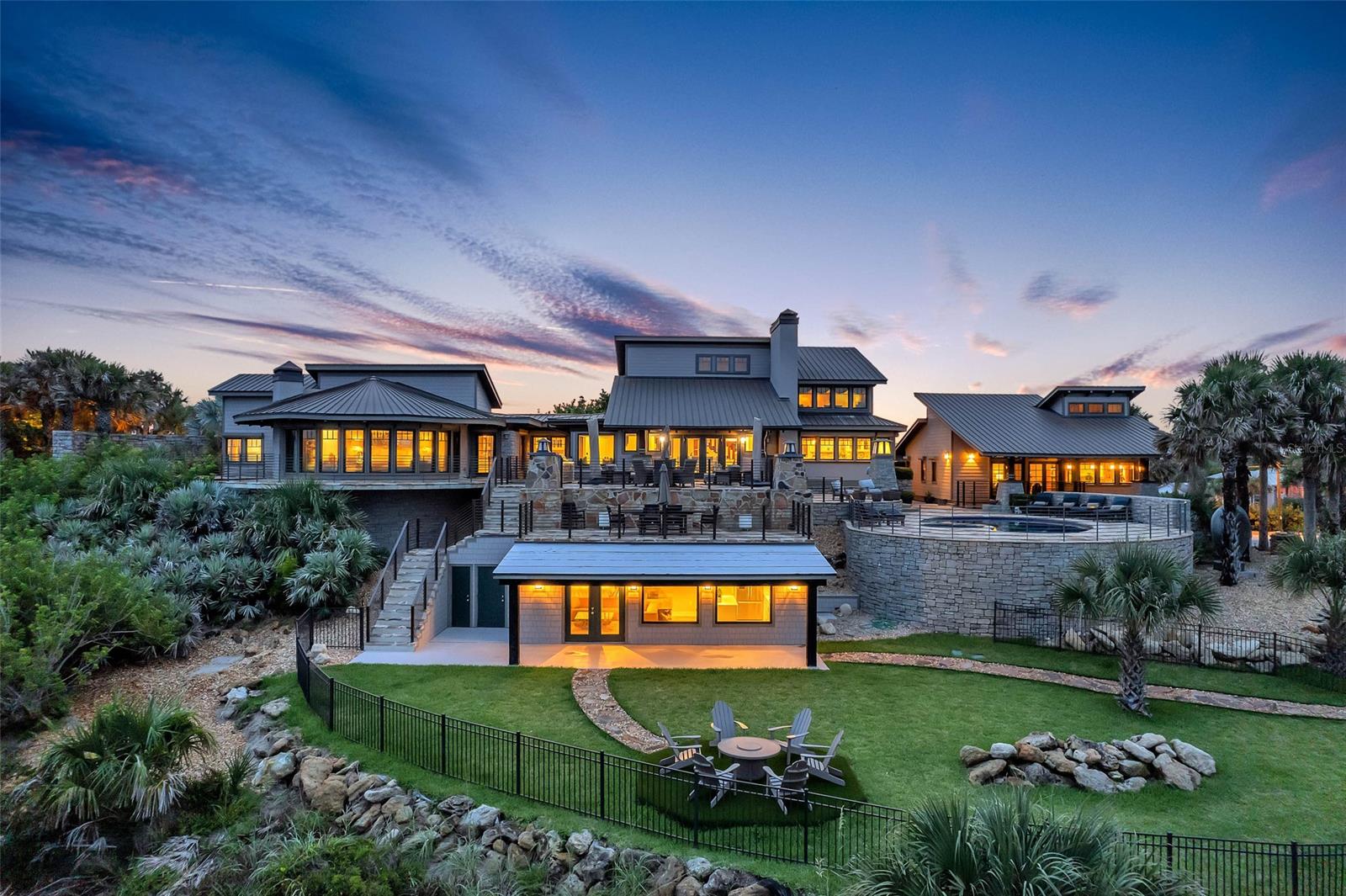 Magnificent and luxurious describes this one-of-a-kind direct ocean front home with guest house. This 6-bedroom 5/2 bath home is located on 1.15 acres, and is one of the largest oceanfront parcels on prominent north beach in New Smyrna Beach. This home has gone through a multi-million-dollar renovation. Surrounded by hand laid stone walls, and flagstone paths and terraces that connect the main home to the guest house and several surrounding garden terraces. The main home has a first-floor master bedroom with expansive panoramic views of the ocean and a spectacular 24 x 10 walk thru closet and located on the south wing of the home for privacy. Beautiful large new eat-in kitchen with custom cabinets, high end granite, spacious island with gas cook top, custom appliances, drink drawers and gorgeous view of the ocean and pool.  Large formal dining and living room with expansive ceilings and oak beams open to a massive flagstone outdoor entertaining deck with 1 of 2 outdoor kitchens. Cozy large family room off kitchen with coffered ceilings brings a wonderful coastal feel throughout. 2nd floor consists of 3 bedrooms and 2 full baths. Treat your guest to their own private ocean view space with this one-bedroom guest cottage that has all the luxury of the main home. Large open floor plan with massive oak beams throughout. Granite kitchen, eat-in nook, kitchen island, private deck and Ocean views from living room and kitchen. 3 car garage with temperature control wine cellar Workmanship and materials in this house make this hard to duplicate. The home features are essential to understanding the design and beauty of the property. Don’t miss out on this opportunity to own one of finest Ocean front homes in New Smyrna Beach. ALL MEASUREMENTS AND INFORMATION ARE DEEMED TO BE ACCURATE BUYERS AND BUYERS AGENT TO VERIFY ** ;Water: City