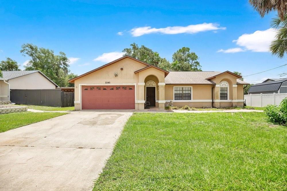 Welcome to this charming, move-in ready 3-bedroom, 2-bath single-family home in the affordable and conveniently located city of Deltona, Florida.  Situated on a spacious 0.23-acre lot (approximately 80x125 ft) with a fully fenced backyard, this residence offers comfortable and affordable living with excellent accessibility to Downtown Orlando or Daytona and New Smyrna Beach. Built in 1989 with 1,626 sq ft of air conditioned living space (2,406 sq ft total), the home features a thoughtful split floor plan with three generously sized bedrooms and two full bathrooms. The primary suite includes a garden tub and separate shower. Enjoy a functional layout with separate living and family rooms, a formal dining area, and a bright kitchen equipped with wood cabinetry, stainless steel appliances, and a stylish backsplash—perfect for everyday meals or entertaining.  Recent updates include an architectural shingle roof installed in July 2022, providing peace of mind and long-term value. Additional highlights include ceramic tile and carpet flooring, a screened-in porch with high vaulted ceilings, an open porch, and a 400 sq ft, 2 Car Garage.  Located just minutes from I-4, this property offers unbeatable convenience for commuters, with easy access to major employment centers, shopping, dining, and recreational amenities. It's also near excellent schools: Forest Lake Elementary (0.9 mi), Deltona Middle (1.9 mi), and Pine Ridge High (5.1 mi).  Whether you're a first-time buyer or seeking a solid investment, this well-maintained home combines comfort, updates, and prime location. Don't miss your opportunity—schedule a showing today!  Key Specs:  3 Beds - 2 Baths - 1,626 Sq Ft Heated - Lot: 0.23 Acres - Built: 1989 - New Roof (2022) - Fenced Yard | Screened Porch - No HOA.  Call today to schedule your private showing.