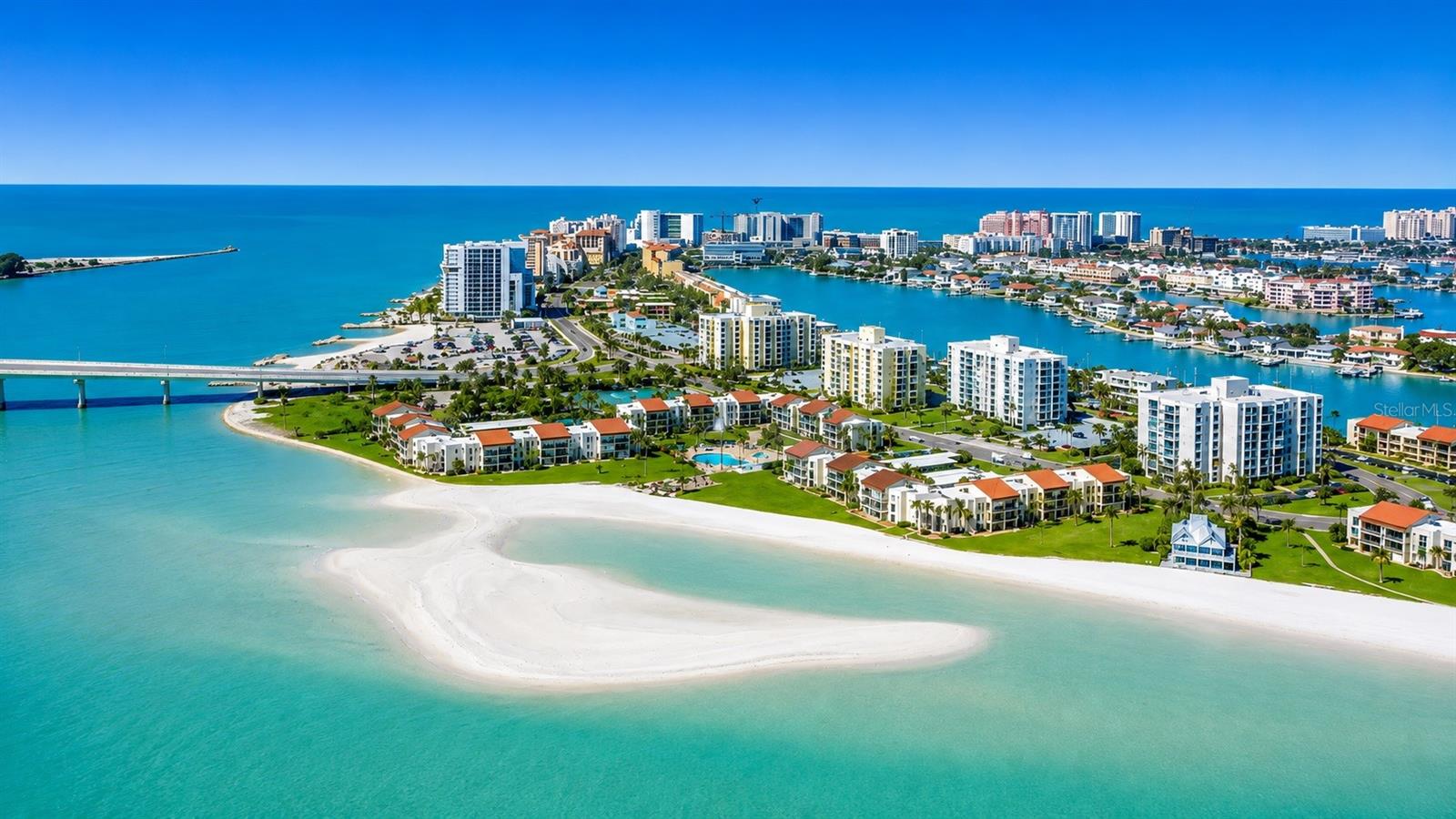 PENTHOUSE CORNER UNIT WITH PANORAMIC WATER VIEWS! Enjoy breathtaking views of the Gulf and Intracoastal Waterway from this light-filled penthouse residence, located just steps from a private beach and directly across from the Clearwater Yacht Club. This beautifully maintained two-bedroom, two-bathroom corner unit offers an exceptional combination of coastal luxury, comfort, and convenience. Interior features include ceramic tinted windows and sliding glass doors, electric hurricane shutters, and an open, airy-layout filled with natural sunlight. Both bedrooms feature private balconies with water views, creating the perfect setting to enjoy morning coffee or evening sunsets. The spacious primary suite offers generous his-and-hers closet space and an updated en-suite bathroom. Additional updates include a newer AC system installed in 2020. Residents enjoy an impressive array of resort-style amenities including three swimming pools, a large spa, tennis courts, pickleball courts, shuffleboard, and beautifully maintained grounds. The unit also includes premium covered garage parking conveniently located directly in front of the building. Ideally situated near world-famous Clearwater Beach, Pier 60, shopping, dining, entertainment, and local marinas. Convenient access to both Tampa International and St. Pete–Clearwater International Airport makes travel simple and convenient. Additional highlights include low HOA fees and a recently replaced roof, offering exceptional value and peace of mind. Whether you are looking for a primary residence or vacation home, this waterfront penthouse delivers the very best of the Florida lifestyle. (Fun Fact: This building is located directly across the street from the future site of The Viceroy Residences Clearwater Beach, a planned ultra-luxury condominium development projected to feature multi-million-dollar residences — making this penthouse feel like an incredible value opportunity, in one of Clearwater Beach’s most exciting evolving waterfront locations.) Call today for a private showing!