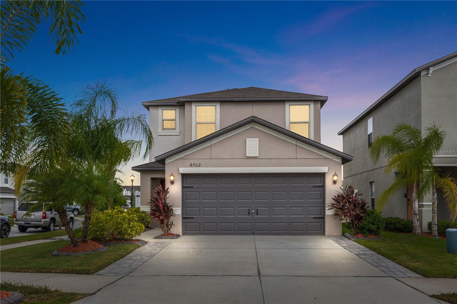 Welcome to resort-style living in the highly sought-after Touchstone community! Situated on a desirable corner lot, this beautifully maintained 4-bedroom, 2.5-bath home offers 2,109 square feet of thoughtfully designed living space with upgrades inside and out. Move-in ready and enhanced beyond the builder finishes, this home features an outdoor entertaining area that's hard to find in the neighborhood. You'll find an extended paver driveway, a covered extended patio with electrical and fans perfect for entertaining, beautifully kept landscaping, updated lighting and ceiling fans throughout, a stylish kitchen backsplash, updated cabinet hardware and fixtures, a newer dishwasher, refrigerator, and washer and dryer. The open-concept first floor offers spacious living and dining areas, while all 4 bedrooms are located upstairs, providing added privacy and a functional layout for families or guests. Step outside to the fully fenced backyard, where an extended covered patio with electricity creates the perfect space for relaxing, entertaining, or enjoying Florida’s outdoor! Touchstone residents enjoy resort-style amenities including a community pool, clubhouse, fitness center, playground, and walking trails, all conveniently located near I-75, the Selmon Expressway, downtown Tampa, MacDill Air Force Base, shopping, dining, and Gulf Coast beaches. 15 minutes from Downtown Tampa! Don’t miss the opportunity to own this beautifully upgraded, move-in-ready home in one of Tampa’s fastest-growing communities. Schedule your showing today!