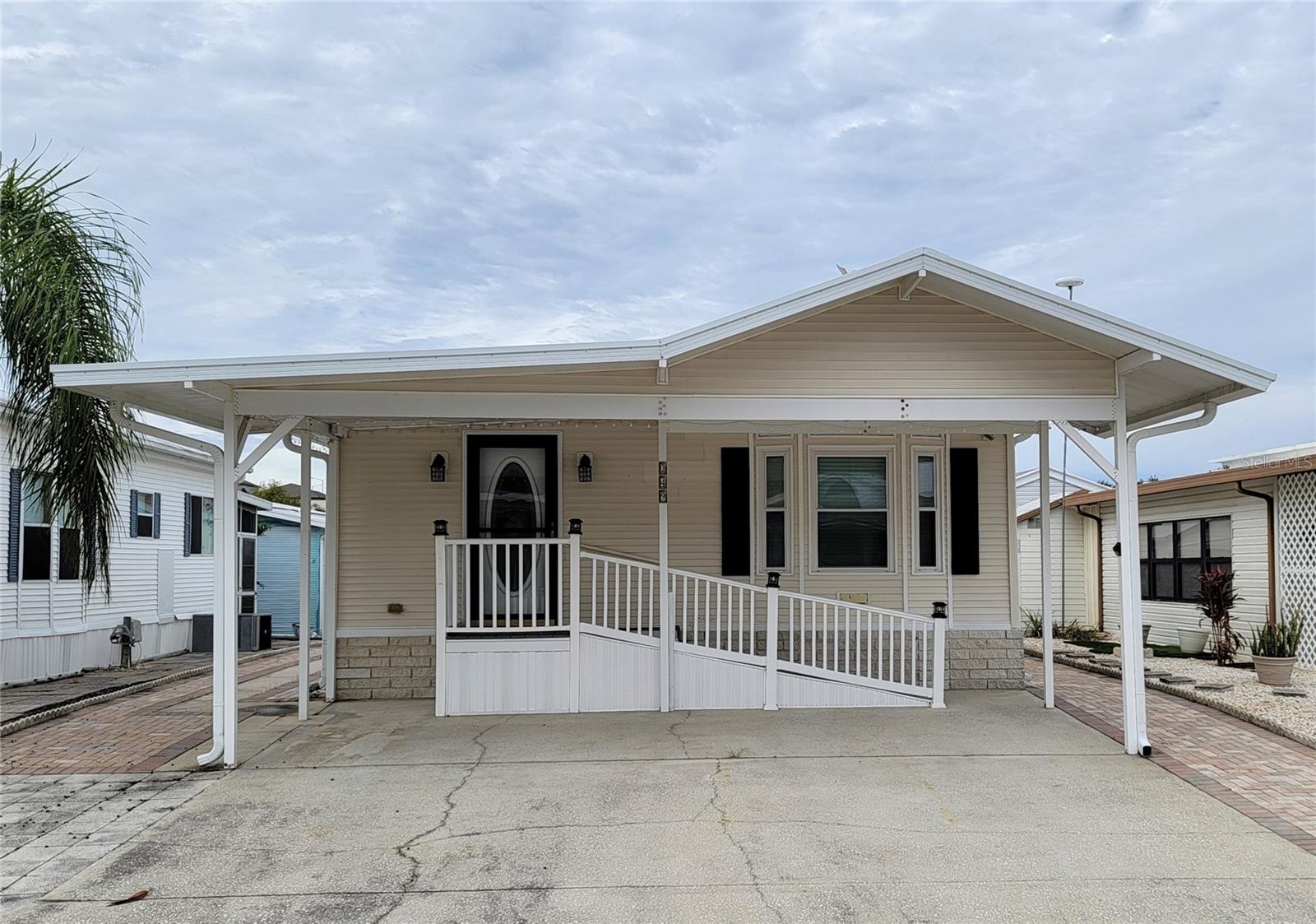 Well kept manufactured home with 1 bedroom plus large living room with a Murphy bed setup. There's a spacious dining room, and a clean kitchen with a separate breakfast nook. There are 2 bathrooms, with the 2nd one also housing the stacked washer and dryer. The master bedroom has built-in cabinetry. There's an additional storage room in the back corner of the structure, accessible from both the outside rear door as well as from the laundry bathroom. The entire property is surrounded by easy maintenance brick pavers, with ample parking. Located in the security gated Active Adult Only 55+ amenity filled community of Center Crest, this home is convenient to shopping, entertainment & medical services along the Hiway 27 / I-4 corridor. You own the land, Fee Simple. There are NO monthly lease fees, with very modest annual HOA dues.