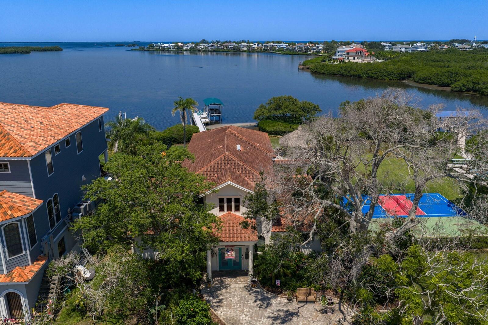 A Rare Gulf-Front Estate with Nearly 1 Acre, 144 Feet of Waterfront & a New Price

Introducing Sea Breeze Island — an extraordinary Gulf-front estate opportunity at 1632 Sea Breeze Drive in Tarpon Springs now offered with a recent price adjustment.

Set on nearly one acre with an impressive 144 feet of direct Gulf frontage, this property delivers the kind of space, privacy, and waterfront lifestyle that is becoming nearly impossible to find along Florida’s Gulf Coast. Positioned on two separately deeded half-acre parcels, the estate offers exceptional flexibility for a future family compound, additional custom residence, guest home, or long-term legacy investment.

From the moment you arrive, the scale of the property stands out — a circular drive framed by mature tropical landscaping, expansive open-water views, and breathtaking sunsets that paint the sky every evening over the Gulf of America.

For boating enthusiasts, the location is truly exceptional. Just offshore, you’ll find easy access to Three Rooker Island, Anclote Key Preserve State Park, and the surrounding island sandbars that make this stretch of coastline one of the most sought-after boating destinations in the Tampa Bay area. Spend your days cruising to secluded beaches, fishing open Gulf waters, or enjoying waterfront dining nearby.

The residence itself has been extensively updated, featuring a beautifully remodeled first floor designed for entertaining and everyday luxury. The chef’s kitchen includes brand-new THOR appliances, a Sub-Zero refrigerator, gas cooking, custom cabinetry, oversized island, and walk-in pantry.

The owner’s suite showcases sweeping Gulf views, a private balcony, spa-inspired bath, and dual walk-in closets. Multiple guest bedrooms, spacious living areas, a private office, home gym, and upstairs media room with built-in bar create endless flexibility for hosting family and guests.

Outside, the estate transforms into a private waterfront resort featuring:

Saltwater pool with new equipment
Outdoor kitchen
Tiki hut lounge
Firepit area
Private pickleball court
Brand-new 2024 dock with Trex decking
Updated electrical
Fish-cleaning station
10,000 lb boat lift

Located just minutes from Tarpon Springs Sponge Docks, Fred Howard Park, and downtown Tarpon Springs, this estate offers the rare balance of privacy, boating access, acreage, and convenience.

This is more than just waterfront living — it’s an opportunity to own a truly rare Gulf-front estate designed for generations to enjoy.