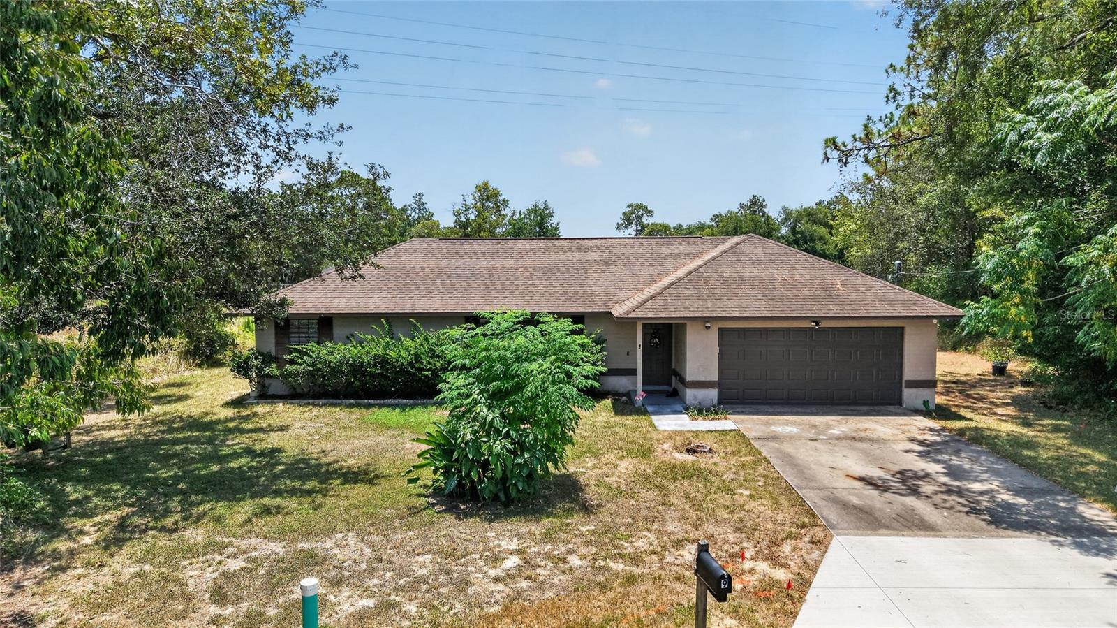 Opportunity awaits with this 3-bedroom, 2-bath home offering 1,485 square feet of living space on a spacious .74-acre cul-de-sac lot in Silver Springs Shores. With a little TLC, this home has the potential to truly shine while already featuring an updated, remodeled kitchen, tile flooring throughout, and a desirable open, split-bedroom floor plan.

Step inside to an inviting living area that flows seamlessly into the dining space and beautifully updated kitchen, creating the perfect layout for everyday living and entertaining. Sliding glass doors off the dining room lead to a covered patio, extending your living space outdoors and providing the ideal spot to relax or host family and friends.

The split floor plan offers added privacy, with the primary suite featuring a walk-in closet and an ensuite bathroom. Two additional bedrooms and a full guest bathroom provide comfortable accommodations for family, guests, or a home office.

Outside, you'll appreciate the oversized backyard with plenty of room for pets, play, gardening, or future outdoor additions. Situated on a generous .74-acre lot at the end of a cul-de-sac and complete with a two-car garage, this property offers space, privacy, and endless possibilities. 

Conveniently located in Silver Springs Shores, you'll enjoy easy access to shopping, dining, medical facilities, and everyday conveniences. Just a short drive from Ocala and The Villages, this home offers the perfect balance of peaceful living with quick access to entertainment, restaurants, and recreation. Whether you're looking for your next home or an investment opportunity, this property is ready for your personal touch.
