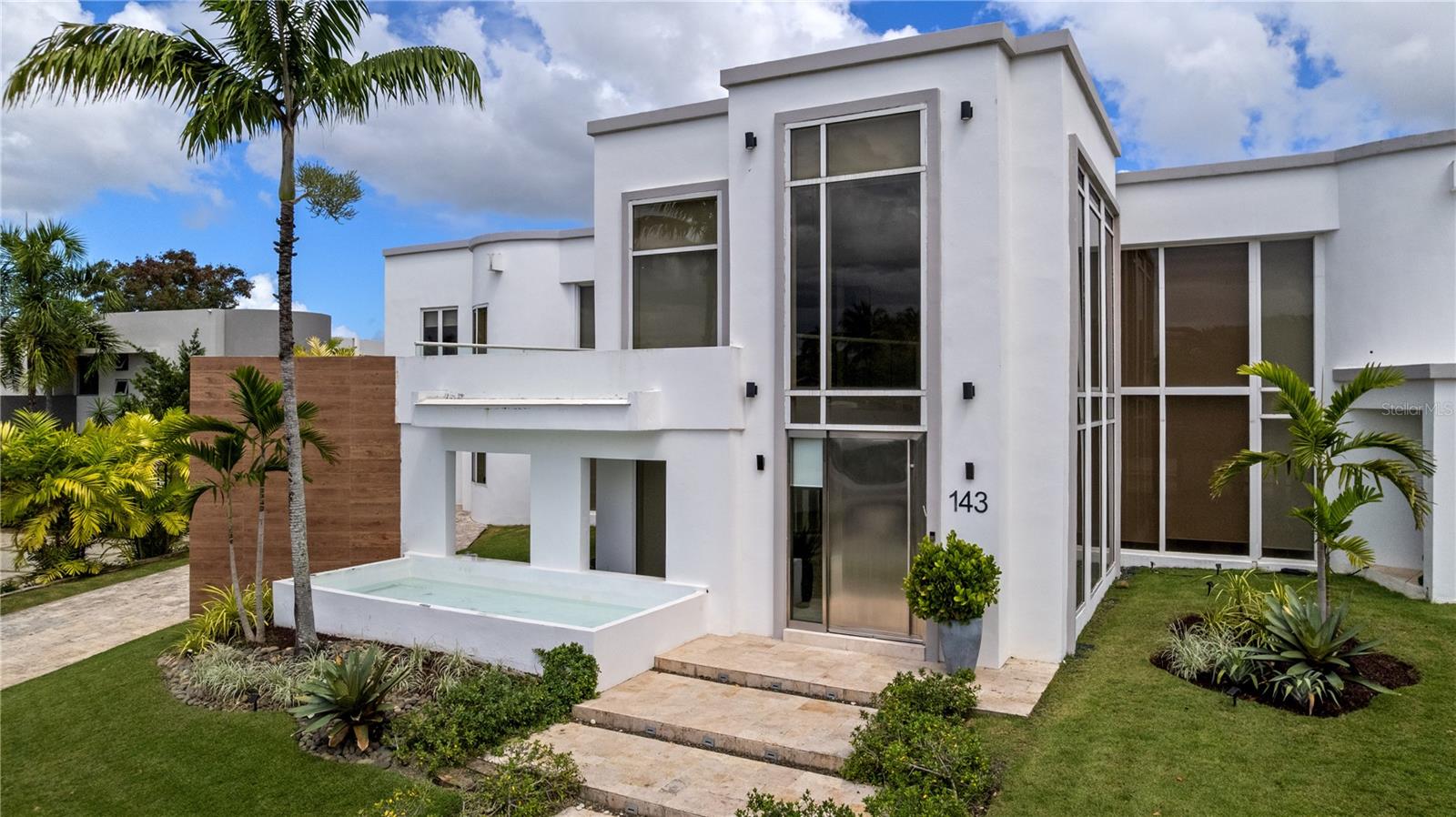 Under contract-accepting backup offers. Exquisite Estate Residence at "La Villa de Torrimar" Community in Guaynabo. This contemporary residence, currently unfurnished, with two level offers a turnkey opportunity with 5 bedrooms and 5 full bathrooms, plus 2 half bathrooms. The Living and dining areas overlook to the pool, and the outdoor gazebo with BBQ/ within its residential amenities a practice soccer field, practice basketball court, green areas, spacious garage for two. Open Space Concept with a fully equipped kitchen with stainless steel appliances, playroom and office area too. On the second level bedrooms enjoy of a family room with balcony and the 4 bedrooms with their own bathrooms, located in this level, have direct access to outdoor terrace. Full Generator, 2 solar water heaters, security cameras, security windows and doors. "La Villa de Torrimar" is a gated community with 24/7 guards, offers tennis courts, pickleball courts, playgrounds, basketball courts, activity rooms and gym.