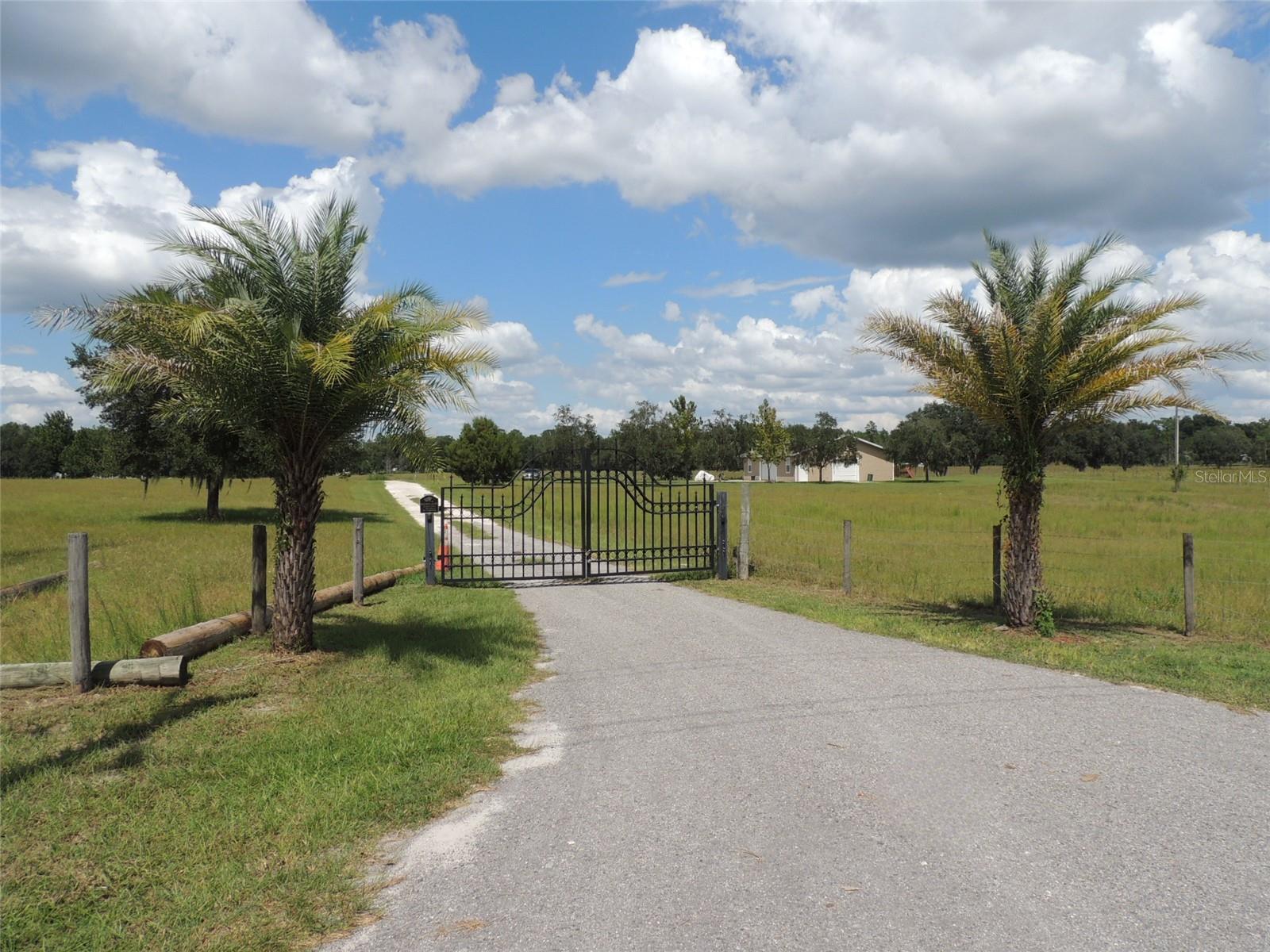 MECHANIC’S DREAM ON 10 ACRES! Looking for the ultimate shop space with room to roam? This unique property is a rare find—combining a spacious 1,500 sq. ft. garage with comfortable living quarters on 10 beautiful acres. The garage is built for serious work, featuring 12’ vaulted ceilings, a 16’ automatic roll-up door, and an additional 10’ manual roll-up door for easy access. Complete with underground electric, a Hanmecson 10,000 lb vehicle lift, and a convenient half bath with deep sink, it’s perfectly equipped for mechanics, hobbyists, or anyone needing oversized storage. The separate living space offers about 532 sq. ft. with its own entrance, including a full bath, bedroom with wall unit A/C, and a mini-split system in the kitchen/living area—ideal for weekend stays or a minimalist lifestyle. High speed internet service with Fiber by Central Florida. Outside, you’ll find front and back pastures, ready for animals, gardening, or future expansion. The property is gated, providing both privacy and security, and enjoys a prime location on paved County Road 102—just minutes from Williston, Bronson, and an easy drive to Gainesville or Ocala.