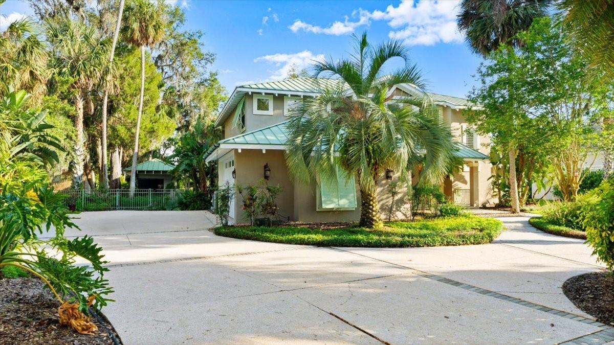 Nestled on over an acre with more than 200 feet of frontage on the Spruce Creek River, this exceptional custom estate by renowned Gittner Construction is located within the prestigious gated community of Palmas Bay. Offering a 16’ x 30’ boathouse, private dock with AZEK decking, floating dock, metal roof, two new air conditioning systems, and all-concrete construction with poured concrete second-floor flooring, this is a rare opportunity to own one of the area’s premier waterfront properties.

Inside, soaring ceilings and rich Brazilian cherry hardwood floors create an atmosphere of timeless elegance. Thoughtfully designed for both everyday living and entertaining, the home features a central vacuum system, spacious light-filled living areas, an en-suite guest retreat on the first floor, an additional guest bedroom, and an expansive second-floor owner’s suite with a private balcony where unforgettable sunrises illuminate the Spruce Creek River as boats glide effortlessly toward the Halifax River.

Step outside to your own private waterfront paradise. Spend the day boating, fishing, kayaking, or paddleboarding from the boathouse, private dock, and floating dock before returning to relax beneath the covered lanai featuring a fully equipped summer kitchen. The fenced backyard provides privacy while showcasing the natural beauty of this extraordinary riverfront setting.

Built with uncompromising quality, the residence features concrete-filled concrete block walls, poured concrete second-floor construction, a durable metal roof, hurricane-rated Bahama shutters, and two new air conditioning systems, delivering exceptional strength, efficiency, and peace of mind.

This is more than a home—it’s a legacy waterfront estate where timeless craftsmanship, unmatched quality, and the ultimate Florida lifestyle come together on one of Spruce Creek’s most spectacular riverfront homesites.