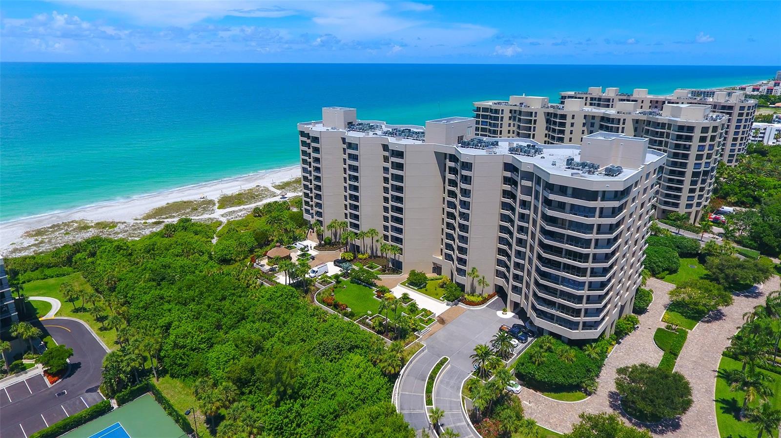 Exceptional opportunity to own this beautifully reimagined first-floor residence at The Promenade on Longboat Key, where luxury coastal living meets sophisticated modern design. Completely gutted and renovated from top to bottom, this stunning condominium offers nearly 400 feet of private beach frontage and partial Gulf of Mexico views from almost every room.
This spacious two-bedroom, two-bath split floor plan showcases a bright, open-concept design ideal for both entertaining and relaxed everyday living. The designer kitchen flows seamlessly into the expansive living and dining areas and features custom cabinetry, premium countertops with full-height backsplash, and top-tier appliances. A custom dry bar with built-in wine cooler and under-shelf lighting adds an elegant touch for effortless entertaining.
Enjoy breathtaking northwest sunset views from the great room or unwind on the private balcony overlooking the Gulf. The luxurious primary suite offers direct balcony access, a large custom walk-in closet, and a spa-inspired en-suite bath complete with a  soaking tub, rain shower system, and large-format designer tile creating a true retreat-like atmosphere. The generously sized guest bedroom provides comfort and flexibility for visitors.
Every inch of this residence has been thoughtfully curated with exceptional craftsmanship and attention to detail, balancing modern sophistication with everyday comfort.
The Promenade offers a true resort-style lifestyle with a 24-hour staffed gatehouse, concierge services, secure under-building assigned parking, heated Gulf-front pool and spa, expansive sundeck with gazebo and grilling area, four Har-Tru tennis courts, fitness center, craft room, and inviting social spaces. Private beach access lined with charming tiki huts completes this extraordinary Longboat Key experience.
Rarely does a completely renovated residence of this caliber become available in one of Longboat Key’s most desirable Gulf-front communities. Experience the ultimate in beachfront living, where every day feels like a vacation.