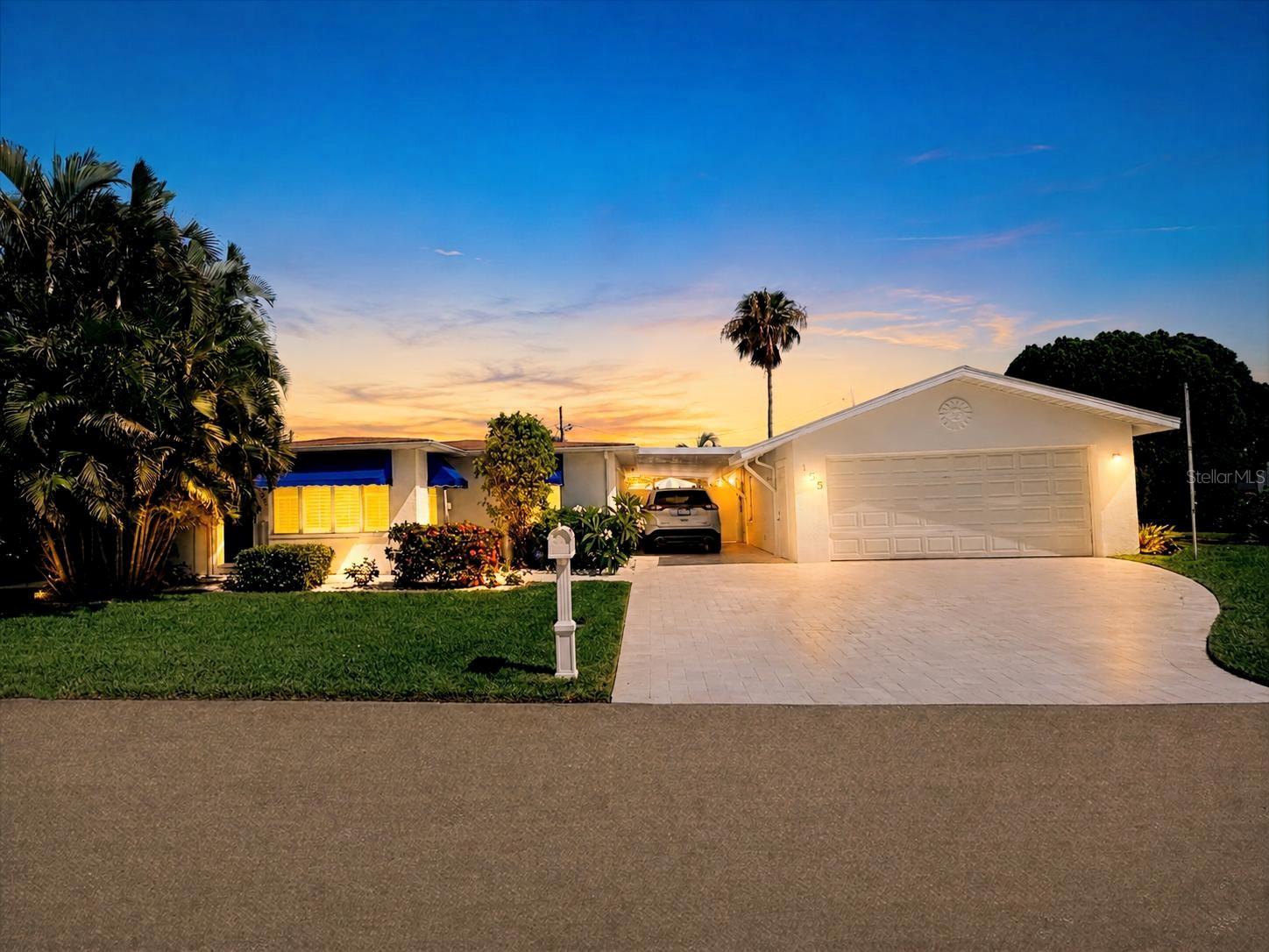 Experience the ultimate Florida lifestyle in this completely renovated 3-bedroom, 2-bathroom home featuring a large, detached 2-car garage plus a carport, ideally located in Treasure Island just two blocks from the beach. Designed for both comfortable everyday living and effortless entertaining, this stunning residence offers an open-concept floor plan filled with natural light and enhanced by the timeless beauty of Shellstone tile flooring that flows seamlessly throughout the home enhancing the bright, beach inspired aesthetic. At the heart of the home is a beautifully appointed kitchen featuring a skylight, GE Café Series white appliances, quartz countertops, and custom two-tone cabinetry with navy blue lower cabinets, white upper cabinets, and soft-close drawers. An electric range is currently installed, with propane available. The kitchen seamlessly flows into the spacious dining area and overlooks the family room, creating an inviting and connected living space. An office area adjacent to the living room provides the perfect setting for working remotely or managing household tasks. The thoughtfully designed split-bedroom floor plan offers privacy and functionality. Two spacious guest bedrooms and a full bathroom are situated on one side of the home, while the private primary suite occupies the opposite wing and features a custom en-suite bathroom. Plantation shutters adorn every window, adding both style and sophistication throughout the home. Step outside from the laundry room to your own private backyard retreat. A screened-in patio overlooks the fenced backyard and pool area, creating the perfect space for relaxation and outdoor gatherings. Enjoy a refreshing swim in the inground pool surrounded by elegant Flagstone pavers, prized for its beauty, durability, and ability to remain cool underfoot on warm Florida days. A pool sweeper simplifies maintenance, while an outdoor shower offers the perfect place to rinse off after a day at the beach. Additional features include solar panels that help reduce electric costs, as well as a combination of solar (Solar Edge HD Wave - owner owned) ,propane, and electric utilities. The home is equipped with a RING SECURITY SYSTEM, and all exterior doors feature FLOOD BARRIER SYSTEMS for added peace of mind. Flood insurance is $3,000. Located directly across from a dog park and playground, this home enjoys a welcoming, family-friendly setting. Situated within a golf-cart-friendly community, you'll be just minutes from the beach, local restaurants, shopping, and entertainment. Whether you're searching for a primary residence, vacation home, or beachside retreat, this exceptional property delivers the coastal lifestyle buyers seek in Treasure Island. Live where others vacation and enjoy everything Treasure Island has to offer—from beautiful sandy beaches and waterfront dining to a relaxed coastal atmosphere that feels like a getaway every day. It's not just a home...it's a lifestyle.