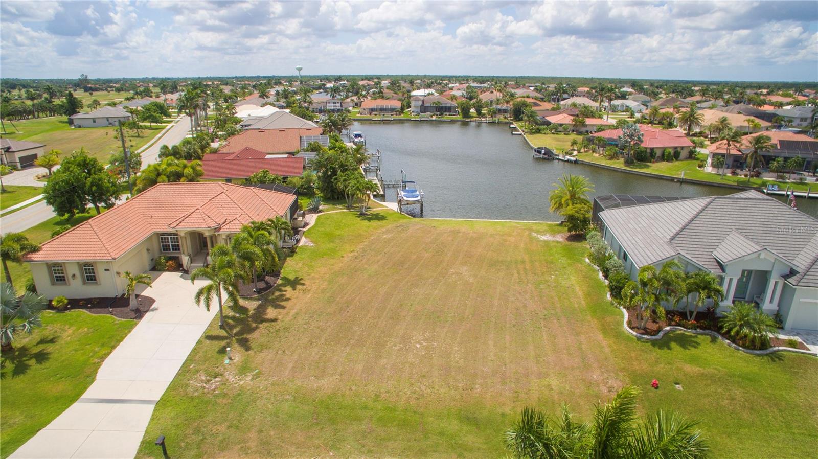 Build your future Southwest Florida waterfront home on this beautiful residential lot in desirable Burnt Store Isles. Offering 10,724 square feet, this waterfront homesite provides no-bridge boating easy access to Charlotte Harbor and the Gulf via Alligator Creek—an outstanding setting for boating, fishing, and enjoying the Punta Gorda lifestyle.  Enjoy improved boating access through the recently widened Burnt Store Isles channel offering enhanced navigation to Charlotte Harbor and the Gulf.  Burnt Store Isles is a premier deed-restricted waterfront and golfing community known for its attractive homes, canals, and convenient location. Punta Gorda maintains the seawalls in both Burnt Store Isles and Punta Gorda Isles, adding long-term value and peace of mind for waterfront owners. Twin Isles Country Club offers golf, tennis, pool, clubhouse, and dining options nearby. Enjoy easy access to Downtown Punta Gorda, waterfront parks, restaurants, shopping, and the area’s 18-mile network of pedestrian and bicycle trails. Design your dream home and embrace the boating, golfing, fishing, and relaxed coastal lifestyle that make Punta Gorda so special.