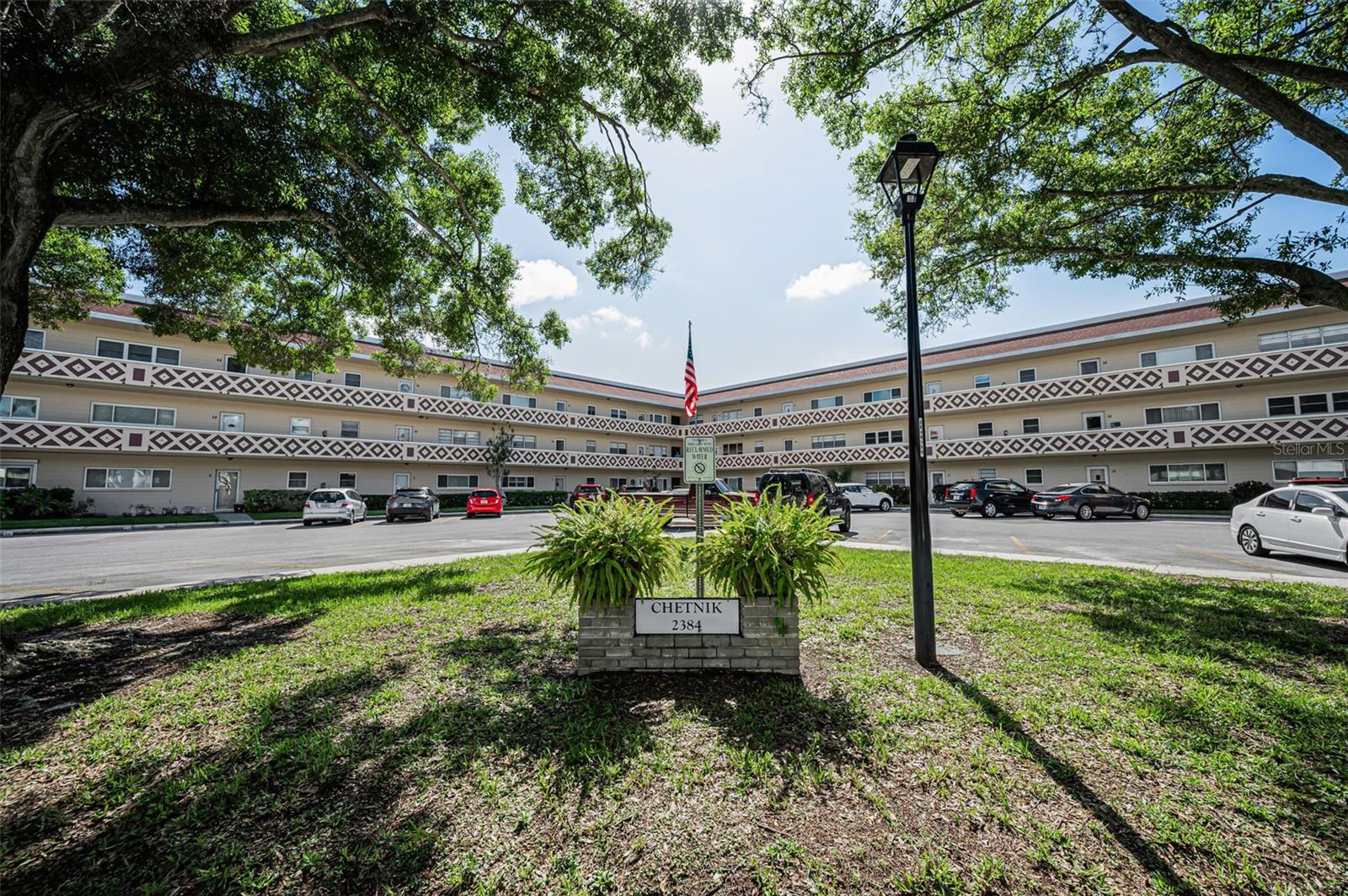 More Than a Condo—A Place to Call Home

This beautifully maintained residence offers far more than just a condominium; it reflects pride of ownership, thoughtful design, and a welcoming blend of elegance and comfort. This second-floor end unit is truly move-in ready and may be exactly what you've been searching for. The popular Emerald Model offers an exceptional amount of living space, plus two spacious bedrooms, two tastefully updated bathrooms, and a versatile Florida room that can serve as a sitting area, dining space, or gathering place for friends and family.
The well-appointed kitchen showcases custom double-stacked wood cabinetry, newer appliances, an inviting eat-in area, and attractive tile flooring that combines beauty and practicality. Home chefs and baking enthusiasts will especially appreciate the upgraded combination oven/convection oven.

Both bedrooms feature comfortable carpeting and custom closet organizers, providing ample storage and organization. The air conditioning system was replaced in 2020 and includes an ultraviolet air purification system for enhanced indoor air quality.
As an end unit, the home benefits from abundant natural light throughout. Hurricane-impact windows provide additional security, energy efficiency, and peace of mind. Just outside the front door is a comfortable alcove area, while the assigned and shaded parking space is conveniently located only steps from the staircase. An abundance of visitor parking spaces make this unit a great venue for friends and fellowship.

Located within the highly desirable On Top of the World community, residents enjoy the added confidence of being situated on one of the highest elevations in Pinellas County, well above potential storm surge concerns. The concrete construction was designed to withstand hurricane conditions, and the required Milestone Inspection has been completed with no Phase II inspection required. In addition, the community has maintained a long history of responsible financial management, resulting in no special assessments throughout its more than forty-year history.

This vibrant 55+ community offers an outstanding lifestyle with an impressive array of amenities, including two activity centers, two heated swimming pools, a fitness center, tennis and pickleball courts, walking paths, hobby studios, a woodworking shop, and two private golf courses; 9-hole and 18-hole, available exclusively to resident owners at no additional fee.

Pet lovers will appreciate the community's pet-friendly atmosphere and fenced dog park. Residents also enjoy a wide variety of activities, including swimming, fitness classes, dancing, clubs, cards, billiards, educational programs, entertainment, tennis, pickleball, and much more.

Conveniently located near Gulf beaches, shopping, dining, entertainment, and transportation, this exceptional home is ideal as either a year-round residence or a seasonal retreat. Combining comfort, convenience, and an active lifestyle, this property offers everything needed to enjoy the very best of Florida living.
