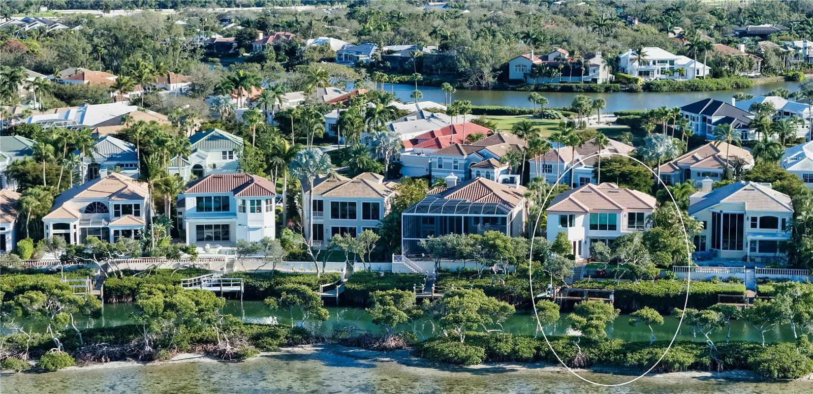 Located within the gated Queens Harbour enclave in Bay Isles, this direct bayfront residence offers a well-designed courtyard-style floor plan with water views, flexible living spaces, and a private dock—set on a quiet cul-de-sac in one of Longboat Key’s most established communities.
Spanning approximately 3,470 square feet of living space across two levels, the home features four bedrooms, four full baths, and one half bath, with a layout that prioritizes privacy and functionality. The first floor hosts three en-suite guest bedrooms, a dedicated office, and the main living areas, while the entire second floor is reserved for the primary suite, creating a true owner’s retreat.
The main level welcomes you with an open living and dining arrangement highlighted by cathedral ceilings, tile flooring, and walls of sliding glass doors that open to the bayfront patio. This seamless indoor-outdoor connection frames tranquil water views, ideal for relaxing or entertaining. The formal dining space also enjoys bayfront exposure and flows naturally into the kitchen.
The kitchen is thoughtfully positioned for daily living and gatherings, offering solid wood cabinetry, stone countertops, a center island, breakfast bar seating, pantry storage, and a full suite of stainless-steel appliances. Adjacent family and living spaces enhance the home’s livability while maintaining clear sightlines to the water.
Two of the first-floor guest bedrooms include en-suite baths, while a third guest suite—a private cabana across the pool courtyard—offers flexibility for visiting family or multi-generational living. The office is also located on the first level, providing the ideal amount of separation.
Upstairs, the primary suite occupies the entire second floor, offering privacy and elevated views. This retreat features a spacious bedroom, walk-in closet, and a well-appointed en-suite bath with dual sinks, soaking tub, separate shower, and private water closet.
Outdoor amenities include a private pool courtyard, open dock with direct bay frontage, providing access for boating and paddle sports. A new tile roof was installed in 2023, and the property includes a two-car garage.
Queens Harbour residents enjoy a maintenance-free lifestyle with 24-hour guard-gated security, community heated pool and spa. Ownership also includes deeded access to the private Bay Isles Beach Club, offering Gulf-front pavilions, grilling areas, and pristine beaches just minutes away.
Perfectly positioned behind the gates of Bay Isles, this residence is close to Harbourside Golf & Marina, the Longboat Key Club, and island dining. St. Armands Circle, Lido Beach, and downtown Sarasota are all within easy reach, providing access to shopping, waterfront restaurants, cultural venues, and year-round events.
A well-located bayfront opportunity offering space, privacy, and a flexible floor plan in one of Longboat Key’s most desirable communities.