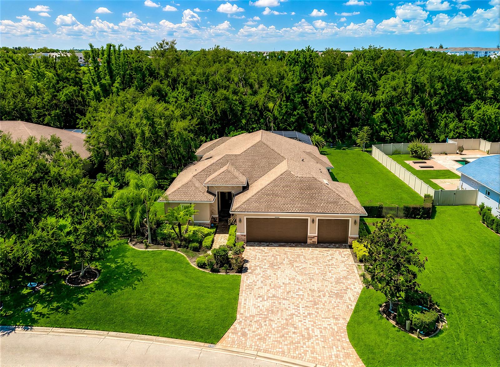 Custom-built by Johnson Homes and situated on over a half-acre in Mill Creek, this home offers features that are becoming harder and harder to find. The oversized homesite, private fenced backyard, screened pool and outdoor kitchen, three-car garage, low HOA fees, no CDD fees, and convenient location near Lakewood Ranch all combine to make this a property you'll want to see.

Mill Creek has long been one of East Manatee County's most desirable communities. Large homesites, mature trees, and custom-built homes give the neighborhood a character that's difficult to duplicate in today's newer developments. You'll enjoy extra space between neighbors while still being just minutes from shopping, dining, top-rated schools, and everything Lakewood Ranch has to offer.

As you step inside, you'll find an open great room floor plan that's perfect for everyday living and entertaining. The kitchen features granite countertops, premium wood cabinetry, stainless steel appliances including a double wall oven, plenty of counter space, and a large breakfast bar that opens to the main living area. Tray ceilings, crown molding, and sliding glass doors leading to the lanai add to the home's custom feel.

The primary suite offers a spacious walk-in closet with custom built-ins along with a bathroom featuring dual vanities, a walk-in shower, and a soaking tub. The guest bedrooms are generously sized, and there's plenty of storage throughout the home.

Step outside and you'll see why homes like this are so popular. The screened lanai, pool, and outdoor kitchen create a great place to relax or entertain, while the fully fenced backyard offers privacy and room for kids, pets, or simply enjoying the extra outdoor space that comes with a half-acre homesite. It's the kind of backyard that's getting harder to find.

Be sure to click the Virtual Tour link for the interactive 3D tour so you can walk through the home before scheduling your showing.
