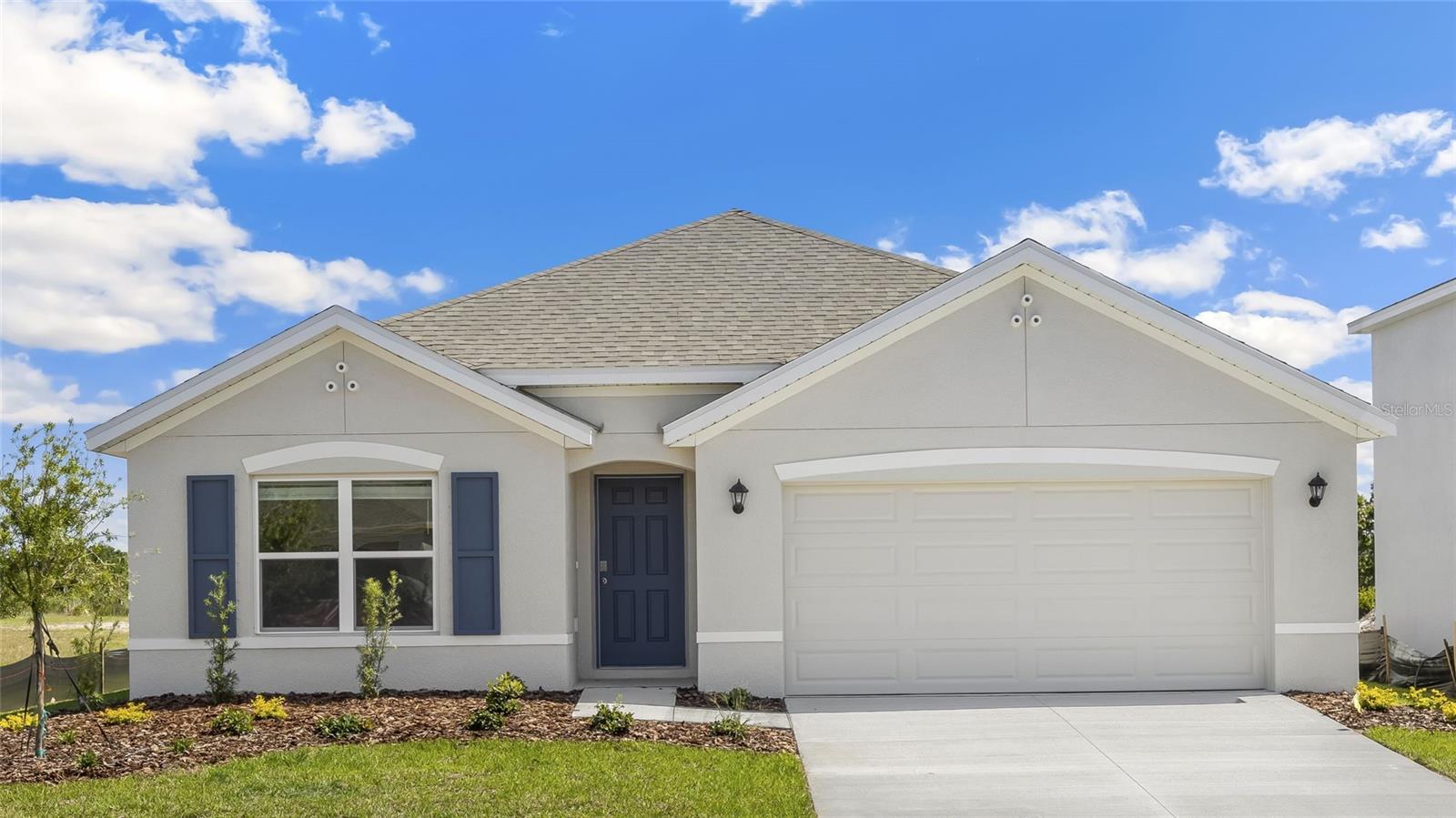 Under Construction. Receive ALL CLOSING COSTS PAID & special interest rates with the use of our preferred lender - Now through June 30th.
Don't miss your chance - only a few homes left in this community!
This all-concrete block constructed, one-story, two-car garage layout optimizes living space with an open concept kitchen overlooking the living area and dining room, which includes extended tile. The well-appointed kitchen comes with all appliances, including a refrigerator, built-in dishwasher, electric range, and microwave. Bedroom 1 with ensuite is located at the back of the home for privacy. Two additional bedrooms share the second bathroom. The third bedroom is located near the laundry room, which is equipped with included washer and dryer. Pictures, photographs, colors, features, and sizes are for illustration purposes only and will vary from the homes as built. Home and community information including pricing, included features, terms, availability, and amenities are subject to change and prior sale at any time without notice or obligation.