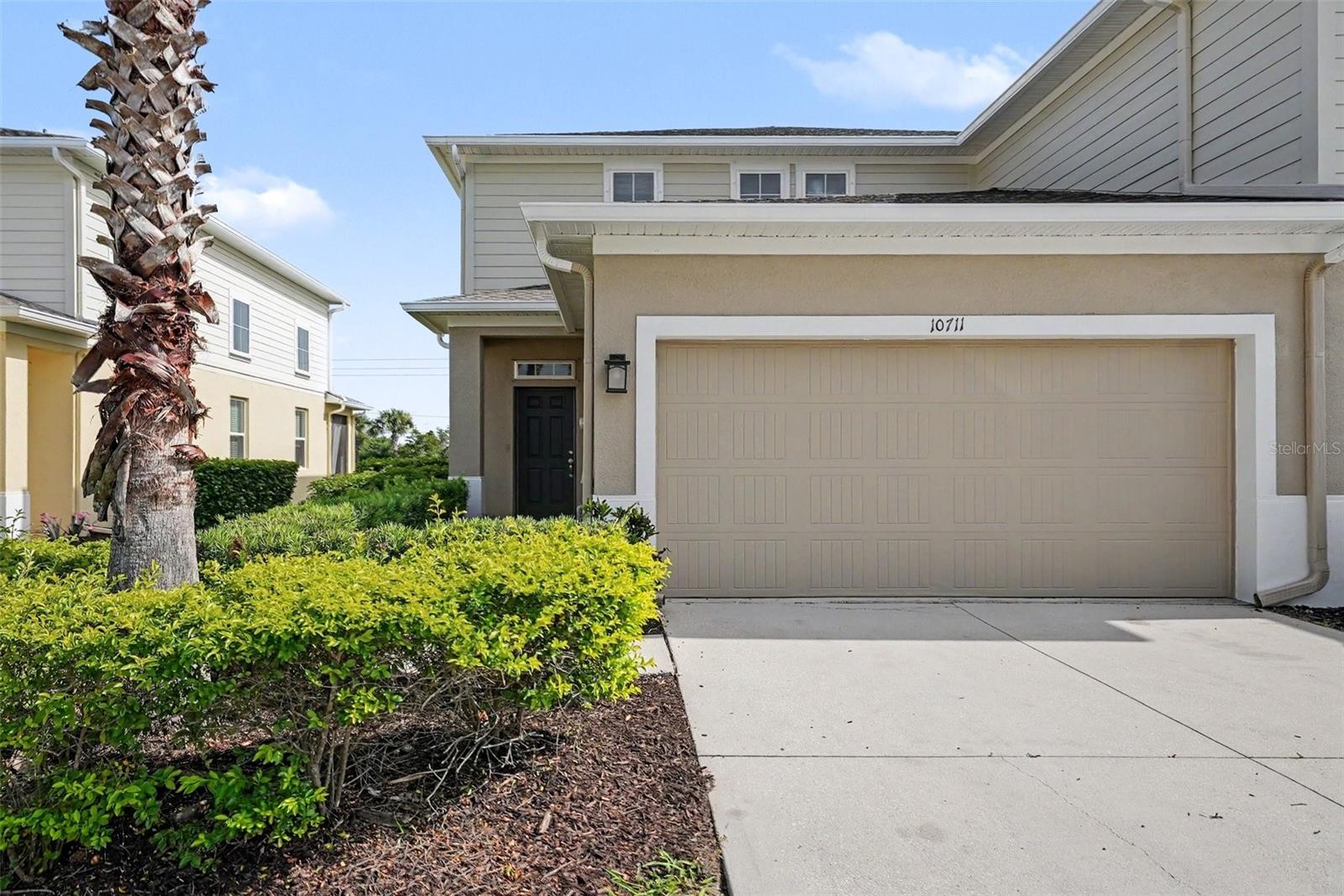 This impressive 3-bedroom, 2.5-bathroom two-story townhome is in pristine, move-in ready condition combining a low-maintenance lifestyle with premium modern upgrades. The heart of the home is the two story living room that offers so much natural light. The beautifully updated kitchen fully outfitted with elegant granite countertops and a sleek suite of premium stainless steel appliances, creates a and highly durable hub for cooking and entertaining. Designed with a thoughtful division of space, the main-floor common areas flow seamlessly together for effortless daily living, while the private quarters transition into quiet personal retreats where plush carpeting highlights all three bedrooms to maximize warmth, quietness, and insulation. The primary bedroom with sought-after first floor location offers an ensuite bath, huge walk-in shower, double sinks and walk-in closet. The upper level houses the additonal bedrooms, as well as a loft area ready for customization. Complete with an attached 2-car garage providing secure parking and excellent extra utility storage, this turnkey residence is meticulously prepared for a completely stress-free transition.