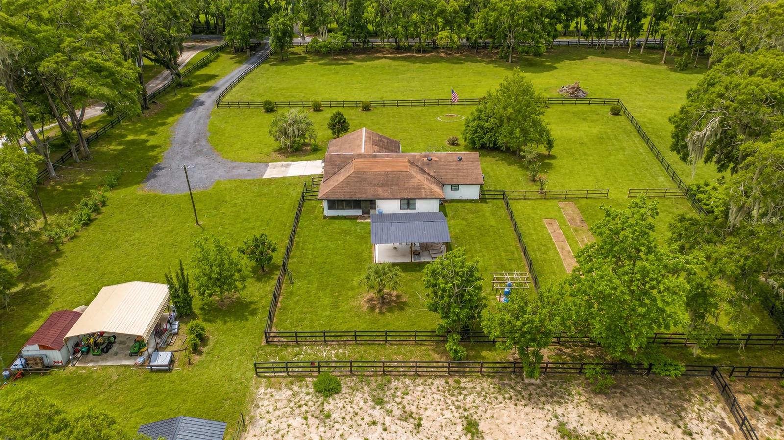 Discover the perfect blend of comfortable country living and functional equestrian living! Set on 6-acres in Anthony, this beautiful horse farm has been extensively updated throughout the property. Fenced and gated, the property is peaceful and private with gentle shade from mature trees. The 3-bedroom, 2-bath home features over 1,900 sq ft of space with a thoughtful split-bedroom floor plan and a variety of upgrades including fresh interior and exterior paint, new ductwork and individual room air filters, new drain field system, new water heater, updated fans, French doors, and a whole-house Generac generator for added peace of mind. New luxury wood-look tile flooring runs throughout the home for easy clean-up, while tall vaulted ceilings create added air to the main spaces and new fans keep the air moving. The kitchen is fully equipped with expansive quartz countertops, soft-close cabinetry, new stainless steel appliances, a breakfast bar, and a stainless steel farmhouse sink. At the back of the home is an enclosed lanai that overlooks the spacious backyard and nearby paddocks. Beyond, a covered gazebo area with power that is an ideal option for a barbecue and for enjoying the outdoors year-round. Both the garage and the lanai are under heat and air thanks to splitters, making both spaces comfortable for year-round usage. Designed with horse enthusiasts in mind, the property includes a custom 3-stall barn built from wood harvested on the property, complete with power, a wash rack, and new automatic waterers. Three fenced paddocks provide ample turnout space and gentle shade. A wooded area is still in-place on the property, opening up the opportunity to clear for further paddocks or outbuildings, or to leave as-is for a more natural landscape. Additional improvements include two RV hookups conveniently located on opposite sides of the home, a storage shed, and multiple outbuildings. Located in Anthony, the property is convenient to both Ocala and Gainesville’s large variety of shopping, dining, entertainment, and medical options, making this a great opportunity for those looking to get the most out of North Central Florida. Whether you're seeking a private equestrian retreat, a hobby farm, or simply room to enjoy a quieter pace of life, this beautifully updated property offers the space, improvements, and flexibility to make it your own!