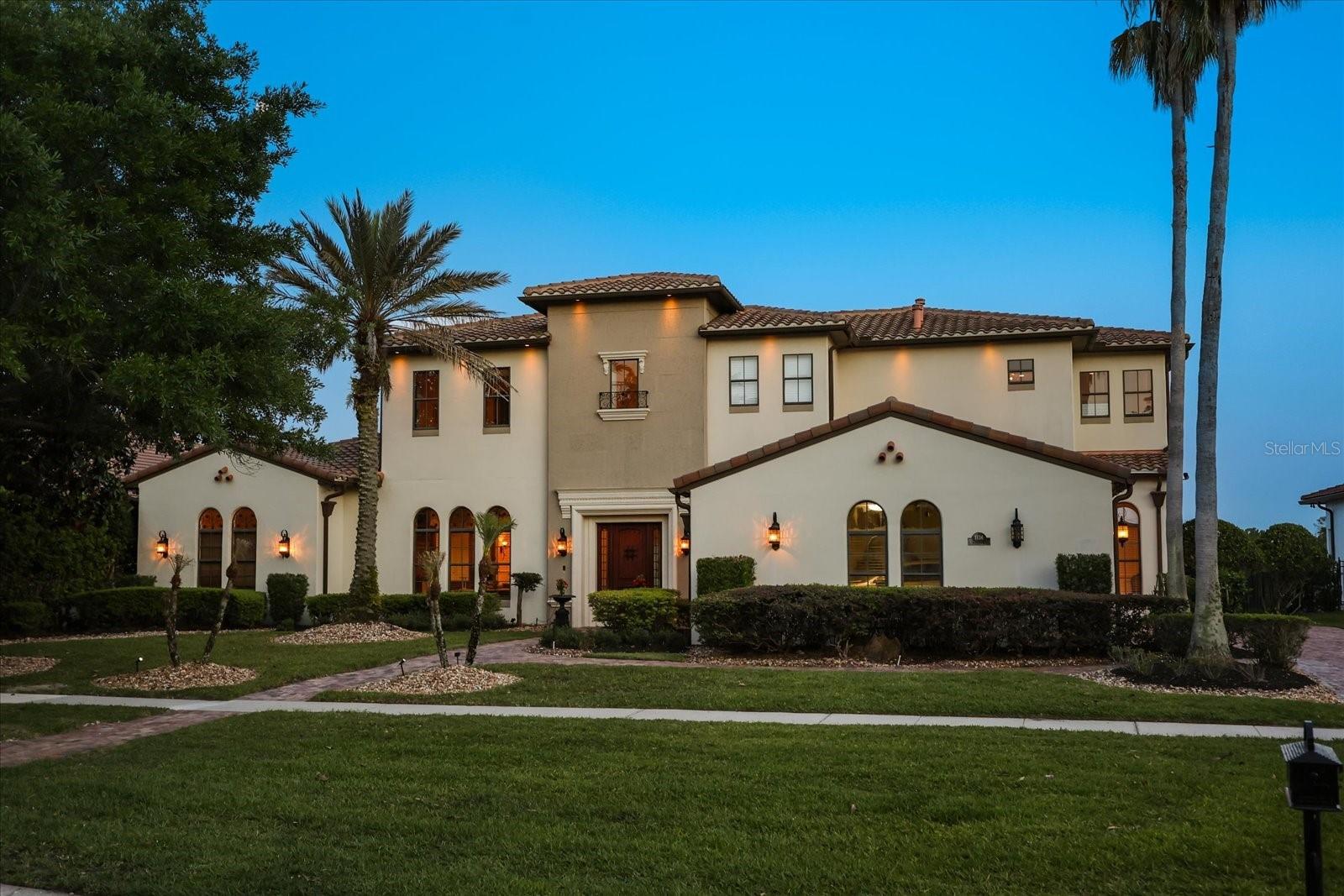 Experience resort-style living in the exclusive Villa D’Este, a masterpiece of sophistication designed by the renowned Arlington Homes. Positioned on the pristine shores of Lake Whitney, this estate welcomes you with a grand 20-foot entryway featuring a custom rustic wrought-iron chandelier and immediate, unobstructed water views.

The main floor is a sanctuary of luxury, featuring an Executive Office with granite built-ins and an opulent Master Retreat. The primary suite is a true escape, offering a Miele coffee system, day bar, and a spa-like bath adorned with Murano-Crystal fixtures, a body-spa shower, and a jetted tub. Culinary enthusiasts will marvel at the Chef’s Kitchen, fully equipped with a custom island, Wolf and Sub-Zero Pro-appliances, Bosch wine refrigeration, and gas cooktop.

The entertainment continues outdoors on the tropical lanai, featuring a heated pool and spa with an in-floor cleaning system, a resort-style cabana with cypress ceilings, an outdoor fireplace, and a full summer kitchen. The entire estate is powered by an RTI Audio/Visual whole-house system. Upstairs, discover a private Theater Room with its own kitchen and a massive balcony perfect for sunset views over the lake. Immaculate, unique, and richly designed—this is the pinnacle of Lake Whitney living.