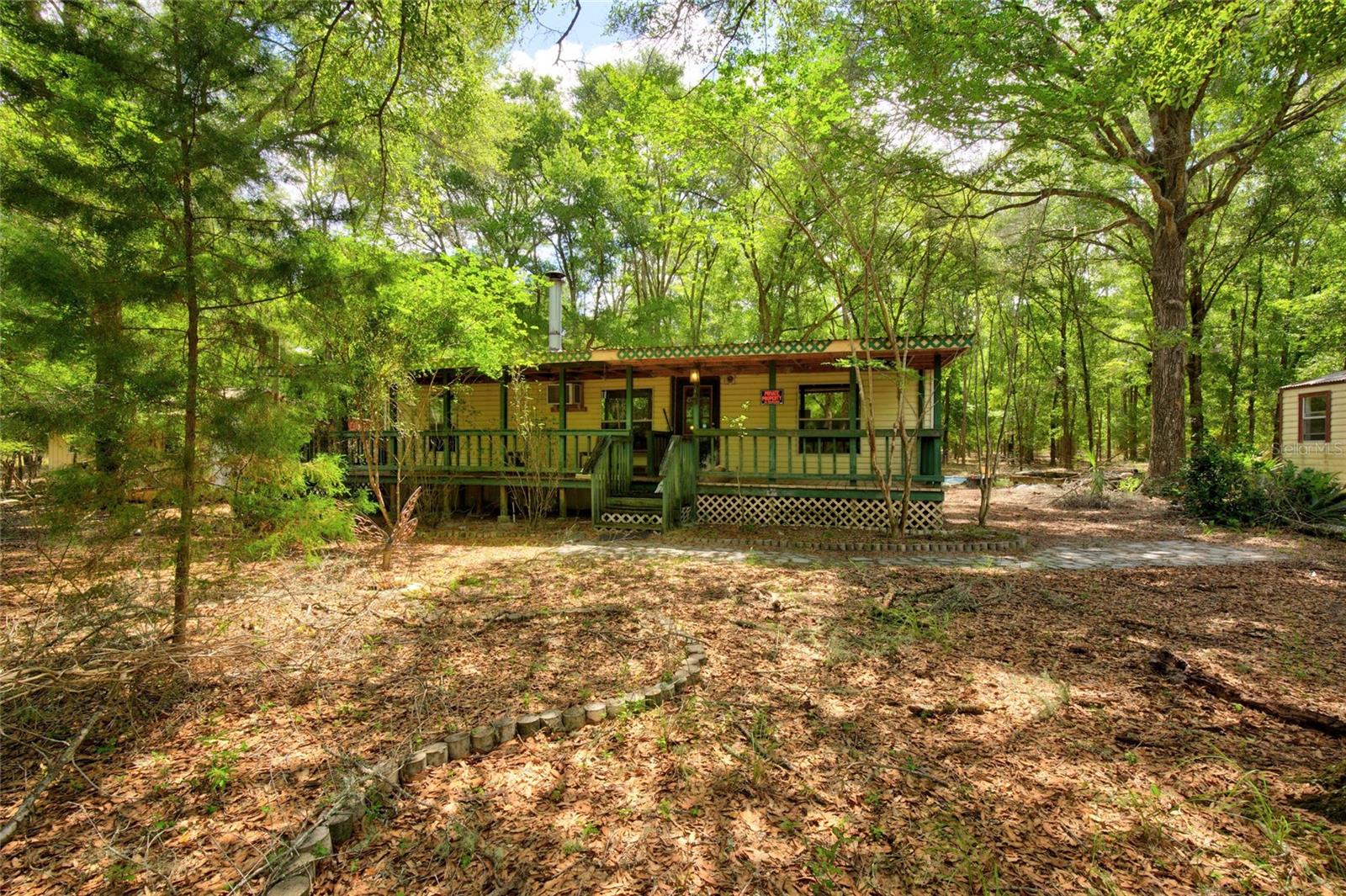 10-Acre Homestead with Two Homes & Workshop in High Springs, FL! Seize this incredible opportunity to own 10 beautiful acres in the heart of High Springs, Florida! This versatile property features two mobile homes, making it ideal for multi-generational living, rental income, or temporary housing while you build your dream home. In addition to the homes, you'll find a spacious free-standing shop, perfect for storage, a workshop, or agricultural use. With plenty of open space, this property is a fantastic opportunity for those looking to develop their dream farm, homestead, or equestrian estate. Located just minutes from downtown High Springs, you’ll enjoy the tranquility of rural living while being close to local amenities, natural springs, and outdoor recreation. Whether you're looking for a turnkey investment or a blank canvas to create your ideal farmstead, this property has endless possibilities!