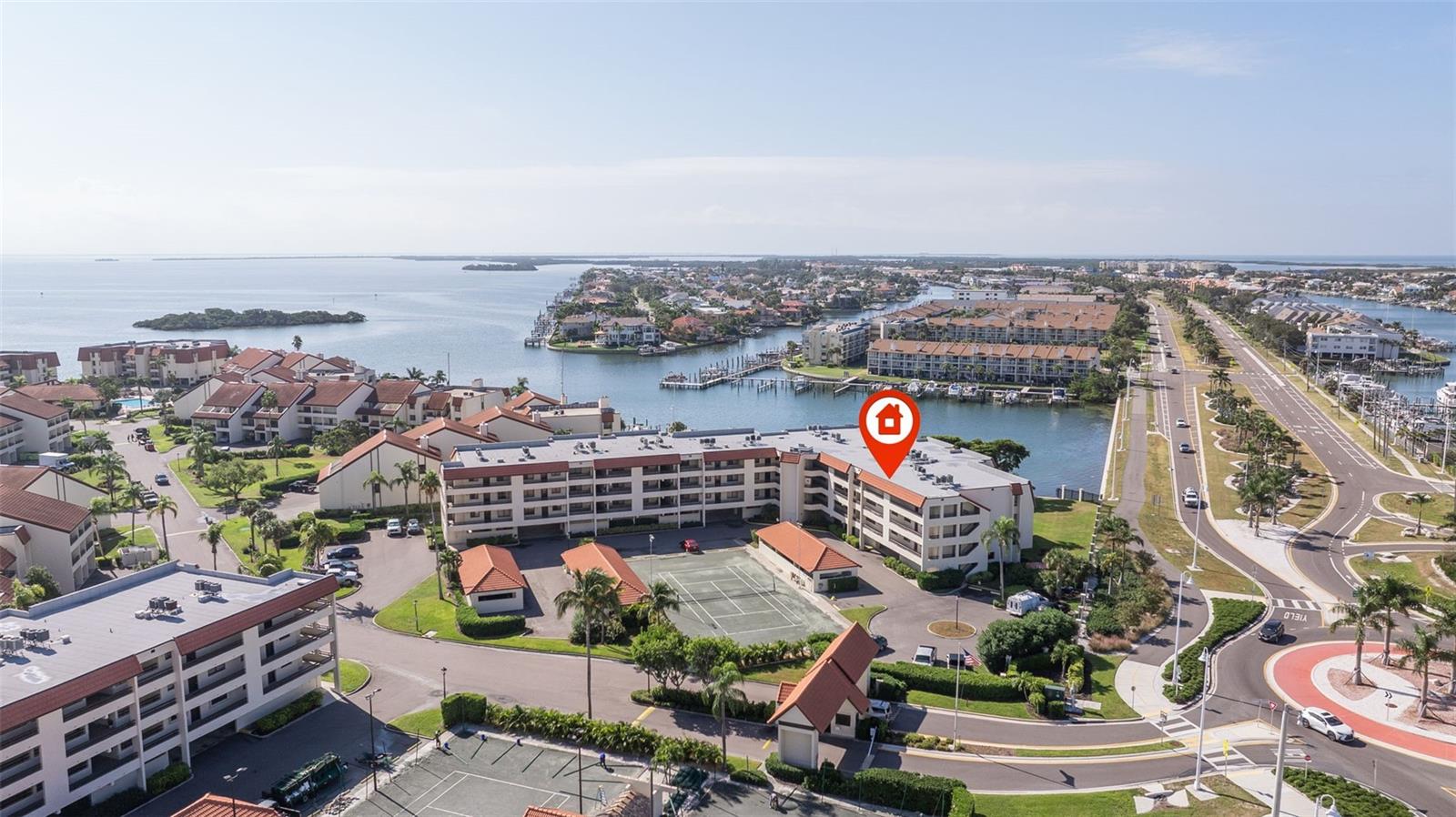 Welcome to the guarded, gated community of The Village at Tierra Verde. The community feature 3 heated pools and spas, tennis courts, open water views all around the property, a recreation center and fishing areas. This beautiful condo features a stunning updated open kitchen with solid wood cabinets and granite counters. You access the waterfront balcony through sliding glass doors in both the living room and master bedroom. There is a stackable washer and dryer and extra storage closet. The second bedroom a=has a built-in murphy bed. The condo is offered mostly furnished.