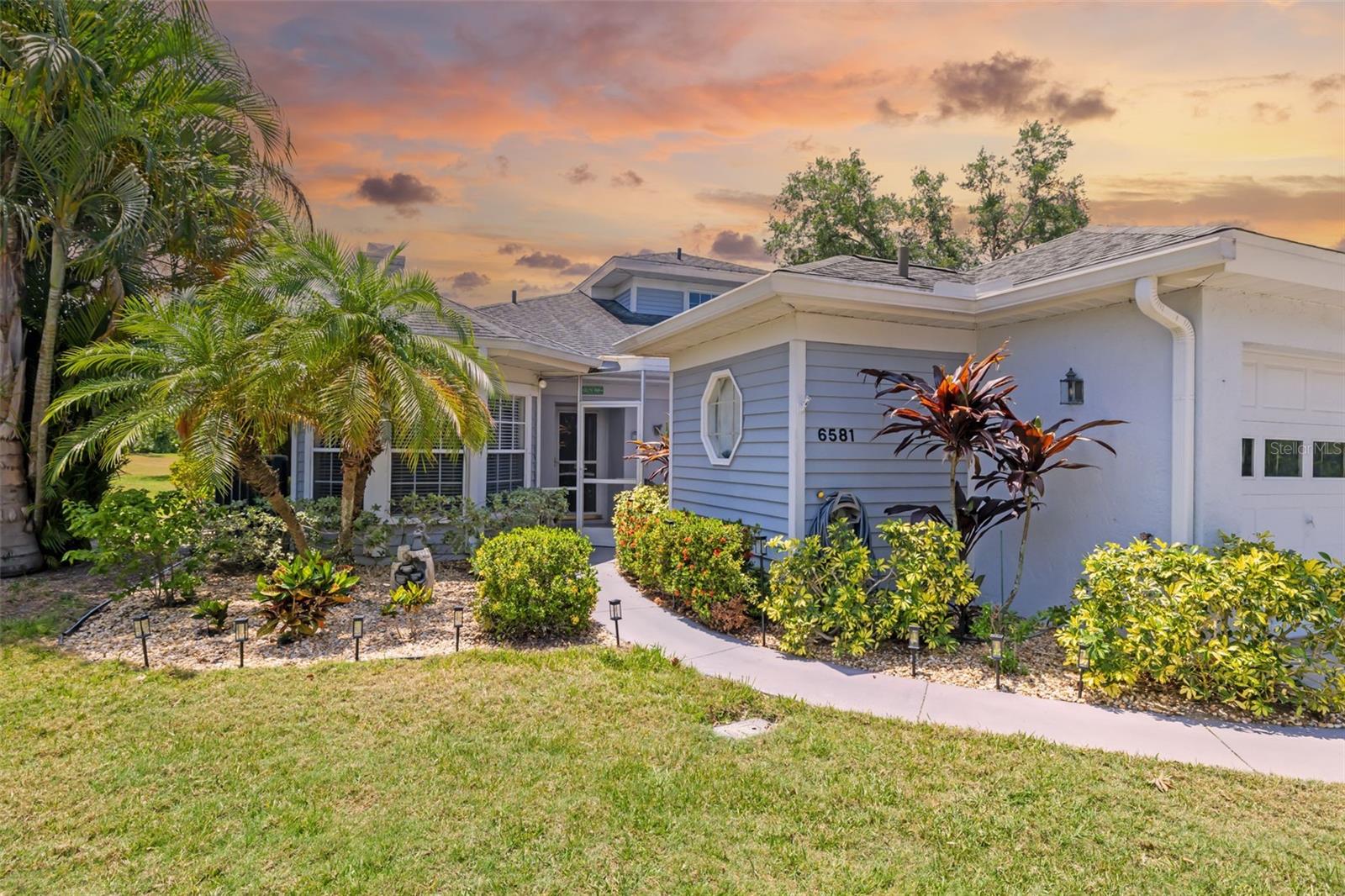 Perfectly positioned directly across from the community amenities, this beautifully maintained villa in Westwoods at Sunrise offers an exceptional combination of space, privacy, and convenience in one of Sarasota’s most established locations. From the moment you arrive, the mature landscaping, corner-unit positioning, and oversized two-car garage create the feel of a single-family home while still enjoying the ease of maintenance-free living. NEW AC 2025!
One of the standout features of this property is its immediate proximity to one of the heated community's pool, which is maintained at approximately 85 degrees year-round, along The clubhouse itself includes a full kitchen and gathering space, making it ideal for social events, entertaining, and community activities. Even more appealing, the association is self-managed with reasonable fees, Maintenance of roofs, exterior repairs, basic cable, and pest control. Residents of this active 55+ community enjoy two heated pools, a pet-friendly atmosphere (up to 25 pounds),  a year-round calendar of fun events, clubhouse, and four premier pickleball courts that residents and friends actively play.
Inside, the home offers nearly 1,850 square feet of living space with soaring ceilings, abundant natural light, and a flexible open floor plan. The spacious living room features a fireplace and flows naturally into the dining area and kitchen, while multiple screened and enclosed outdoor living spaces create seamless indoor-outdoor living. A large Florida room surrounded by windows provides additional versatile living space perfect for relaxing, entertaining, or enjoying peaceful green views.
The kitchen is centrally located with stone countertops, breakfast bar seating, pantry storage, and solid wood cabinetry. The split-bedroom layout provides privacy, with the primary suite occupying the upper level complete with vaulted ceilings, en-suite bath, and walk-in closet. Guest accommodations on the first floor allow flexibility for visitors or multigenerational living.
Outdoor living is another highlight, with multiple screened patio areas, balcony access, and lush landscaping surrounding the property. The oversized garage offers excellent storage and functionality rarely found in villa-style properties.
Located just minutes from shopping, dining, Sarasota Memorial Care Center, golf, and Siesta Key Beach, this home also provides quick access to I-75 and all the cultural attractions Sarasota is known for. Schedule your private showing today and discover the comfort, convenience, and lifestyle this exceptional Sarasota villa has to offer before this opportunity is gone.