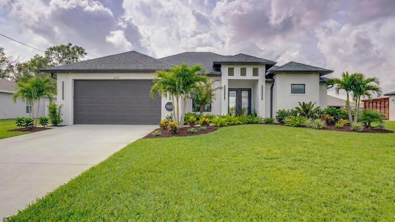 One or more photo(s) has been virtually staged. A RARE find in Lehigh Acres — A NEWER CONSTRUCTION HOME WITH A LARGE POOL & a fully fenced backyard OASIS. This modern retreat blends luxury finishes with effortless indoor–outdoor living, creating a home that feels both stylish and welcoming. *** Enter through 8' double doors into an oversized foyer. Volume and tray ceilings, generous recessed lighting, and sleek oversized tile flooring create a bright, open space. Custom dual-sheer (zebra) blinds, 8' interior doors, and high-end fans & fixtures add a designer touch throughout! *** The open-concept great room flows into the kitchen & dining area with an abundance of natural light from picture windows & sliding doors. The chef’s kitchen features a large island with seating, soft-close cabinetry, granite countertops, custom backsplash, pantry, and new high-end appliances. The dining area overlooks the lanai and pool, framed by picture windows and a statement light fixture. *** The split-bedroom floor plan includes 4 bedrooms and 2 bathrooms. The primary suite is a true retreat with sliders to the lanai, tall tray ceiling, two walk-in closets, private water closet, double granite vanity, soaking tub, and a walk-through tiled shower with dual rainfall heads & hand sprayers. 3 additional bedrooms provide flexibility; 2 have walk-in closets and 1 has backyard access. The guest bath has a walk-in tiled shower and granite vanity. Laundry room with utility sink and storage. Garage with shelving and EV-charger outlet. *** Step outside to your personal paradise. The expansive paver lanai with LED lighting offers ample space for relaxing or entertaining, overlooking the sparkling pool with tropical landscaping & privacy fencing. The custom pool includes programmable LED lights, a DEL AOP25 Ozone + UV sanitation system, bottom filtration, and easy maintenance. Fresh St. Augustine sod and an upgraded sprinkler system complete the outdoor space. *** No HOA, No flood insurance required., just modern luxury & effortless living. It’s everything you’ve been searching for!