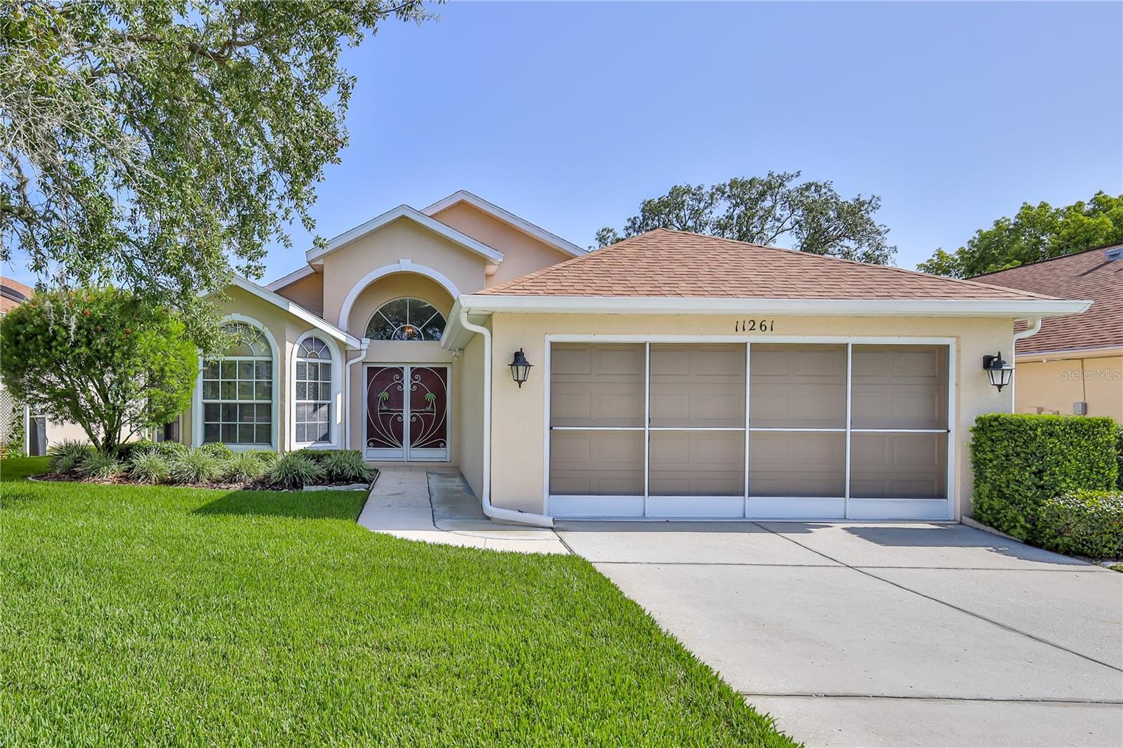 Virtually Staged. Move right into this Lovely 3/2/2 in upscale 55+ Community & start living the Florida Dream. Beautiful, well cared for home, priced to sell with 1,718 sq. ft. of living space. This 3/2/2 split bedroom plan offers neutral tile flooring everywhere except bedrooms. Primary Bedroom has wood laminate flooring, double vanities, sweeping counterspace, Solar Tube, & Snail Shower for ultimate convenience. Open floor plan w/high vaulted ceilings. Kitchen-great for entertaining & the nook is huge. Double Doors/w/Storm Doors leads to oversized entry w/coat closet for extra storage. Formal dining w/bay windows doubles as den, office, etc. Great Rm. w/Slider to Enclosed lanai with tile flooring & garden view allows you to enjoy & extending your living space. Transom window above slider allowing more natural light into this bright, cheerful home. Inside utility room includes the washer & dryer. Home has Water Softener, Leaf Filter Gutter Guards for the ultimate peace of mind, tinted windows. You will enjoy the lifestyle afforded by this Gated Community with 24 manned security, year-round heated community pool, spa, 18,000 Sq. Ft. Clubhouse w/Ballroom, Restaurant (to dine in or take out), Billiards, Fitness Center, Library, Heated Pool, Bocce, Tennis, Pickleball and more. Be as active as you want to be with the many activities and clubs. Newly completed road paving. Sidewalks for walking and benches to relax on where you will enjoy the extraordinary landscaping. Your fees include, fiber optic internet, and Streaming. This home has an exterior maintenance plan for additional fees. All just 45 minutes from Tampa and close to local beach where there is kayaking, fishing and boating. Great local restaurants too.