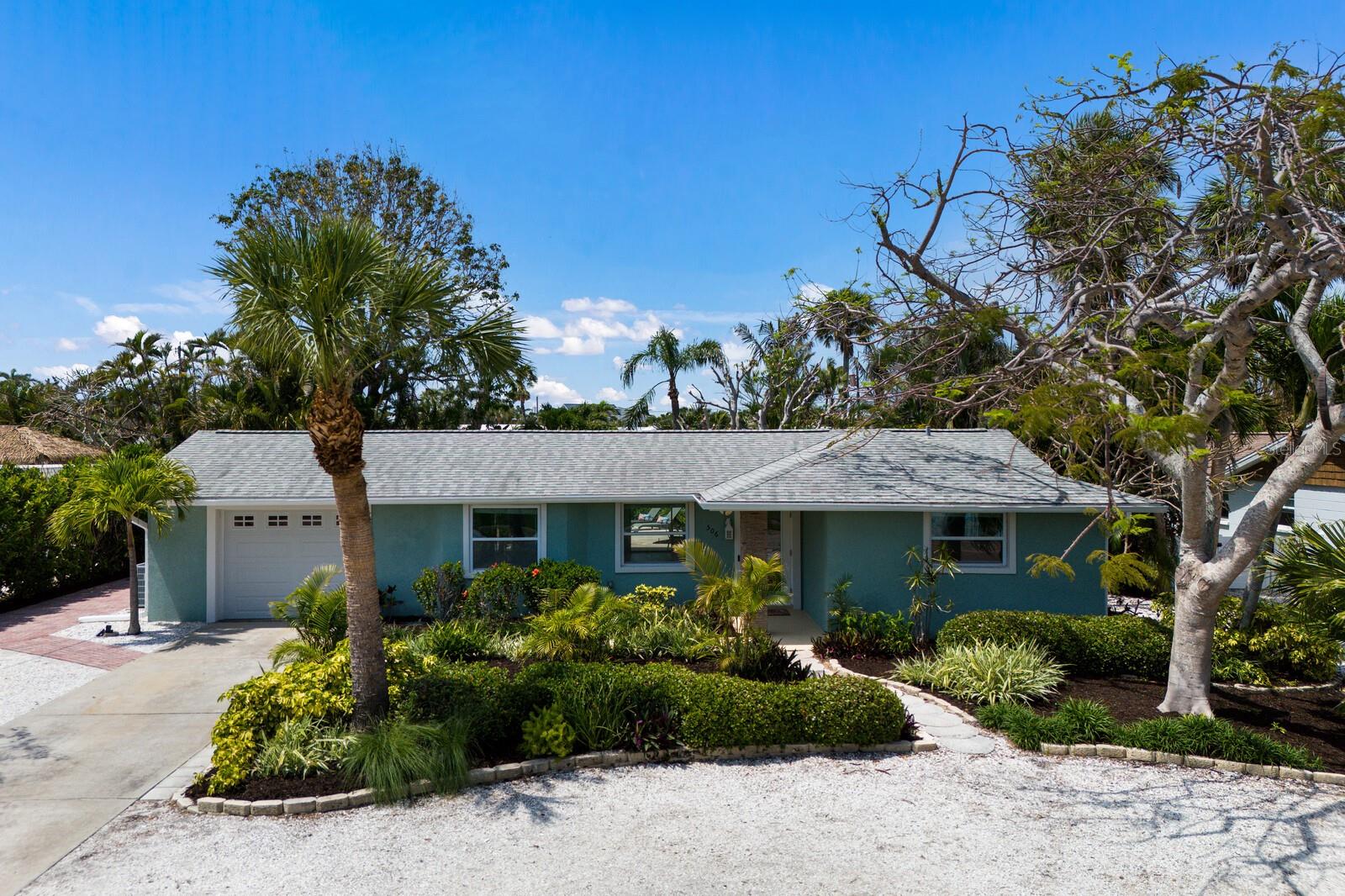 This beautifully updated 2 bedroom, 2 bath pool home offers comfort, flexibility, and exceptional value in the heart of Holmes Beach, featuring a spacious bonus room that can easily function as a third bedroom, office, game room, bunk room, or creative space tailored to your needs. Now offered at a newly improved price, this property presents an exciting opportunity to own a versatile island retreat just minutes from the beach. Wrapped in mature tropical landscaping, the private backyard oasis is designed for both relaxation and entertaining, complete with a heated pool, outdoor shower, firepit area, and multiple shaded lounging spaces perfect for unwinding after a day in the sun. Inside, the open concept layout enhances the flow between living and dining areas, with pocket sliders that open fully to the spacious rear porch, creating seamless indoor and outdoor living. The fully remodeled kitchen is a true highlight, showcasing crisp white cabinetry, sleek countertops, stainless steel appliances, and a generous island ideal for gathering. The primary suite offers a peaceful escape with a well appointed ensuite bath featuring a walk in shower, double vanity, and accessible design. Additional features include a one car garage with a freshly coated floor. Located just a short golf cart ride from the beach, shopping, and dining, this move in ready home delivers easygoing island living with the flexibility today’s buyers are looking for.