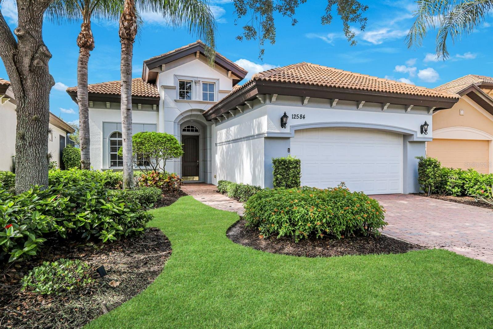 Welcome to this beautifully appointed 4-bedroom, 2-bath home nestled in the sought-after Savona neighborhood within the Grandezza Golf & Country Club. Built in 2005, this spacious residence offers serene lake views and southern exposure, bathing the pool, spa, and expansive lanai in natural light all day long making it the ultimate setting for entertaining or simply unwinding in paradise.
Inside, the open-concept layout features a beautifully appointed kitchen with granite countertops, a decorative tile backsplash, cabinets with crown molding, and a curved breakfast bar that flows seamlessly into the great room and breakfast nook, all overlooking the lanai. Tray ceilings highlighted by crown molding add an elegant touch throughout. The generous primary suite opens directly to the lanai and offers two walk-in closets plus a spa-inspired bath with dual vanities, a soaking tub, and walk-in shower. Three additional bedrooms provide flexibility for guests or a home office. Built-in speakers deliver surround sound in multiple rooms, while plantation shutters and decorative window treatments add a refined finish. Tile flows through all living areas with hardwood and carpet in the bedrooms.
Grandezza residents enjoy world-class amenities including a resort-style pool, tennis courts, bocce ball, walking paths, a fully equipped fitness center, and a stunning 53,000 sq ft clubhouse with pro shop and dining. Golf membership to the 18-hole championship course is optional. Ideally located in Estero, just minutes from RSW Airport, Miromar Outlets, Gulf Coast Town Center, and top dining