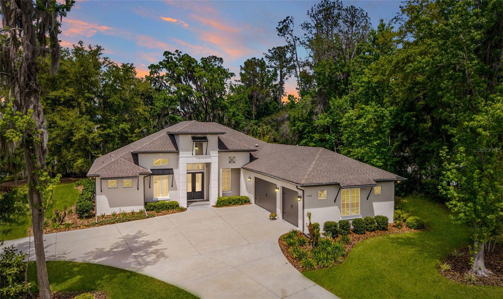 MOTIVATED SELLERS! Don't miss out on your chance to experience elevated living in this executive 4 Bedroom/3.5 Bath home, situated in the premier, centrally located Cedars of Bellechase. Set along the oak-canopied 475 corridor, this distinctive gated community offers exceptional privacy while remaining just minutes from major hospitals, shopping, dining, and more. This impeccably crafted Irvin custom-built home offers refined craftsmanship and impressive presence with a prime location on the corner lot of an oversized cul-de-sac. The property welcomes you with outstanding curb appeal and a striking Y-shaped driveway that leads to a spacious three-car garage. The garage includes an additional six feet of width that creates a versatile area measuring six feet by twenty-three feet, ideal for a workshop or extra storage space. Designed to surpass expectations, the interior of this residence has been immaculately maintained and features a gracious and highly functional layout. Volume ceilings elevate every room of this home, with the great room, dining room, study, and foyer featuring thirteen-foot ceilings. The kitchen and primary bedroom offer eleven-foot ceilings, and the remaining areas present ten-foot ceilings. Beautiful tray ceilings and wooden beams add architectural elegance throughout the home, and granite surfaces are featured in every area. The great room exudes elegance at every turn, anchored by an impressive electric fireplace that adds warmth and visual appeal. Dramatic 13-foot vaulted ceilings with exposed wood beams enhance the sense of volume, and triple glass sliders open seamlessly to the outdoors and frame peaceful tree-lined views. The open layout transitions seamlessly into the designer kitchen, showcasing refined finishes and effortless connectivity centered around a large island with a stainless steel double bowl farmhouse sink and a built-in mini refrigerator. Whirlpool appliances include the refrigerator, oven, and microwave, and a separate pantry provides desirable storage space. A casual breakfast nook opens to the paver-lined covered lanai, which offers an outdoor kitchen that makes entertaining a breeze with a four-burner Bull gas grill, a separate two-burner cooktop, a sink, and a beautiful eighteen-inch Komado grill. There are four total bedrooms with the primary suite offering a luxurious retreat with a soaking tub, a large walk-in shower, and separate closets for added convenience. The home also includes three and a half bathrooms, including a Jack and Jill bath between two guest rooms, a dedicated study, and a charming sitting area with a built-in window seat and storage. The sitting area can be reimagined as a hobby room or additional office, with ample wall space for two desks, ideal for kids or remote work. Multiple storage closets add priceless convenience, and the well-appointed utility room features a GE washer and dryer, mud bench, and a large stainless-steel sink with a folding table. Exterior can lights dramatically enhance the front elevation, garage, and side windows for a striking nighttime look, and the beautifully maintained landscaping is supported by an automatic sprinkler system. Energy-efficient foam insulation adds comfort and structural strength, and the home’s luxury and thoughtful design create an extraordinary living experience for the discerning buyer. Don’t miss the chance to make this extraordinary home yours and schedule your private showing today.