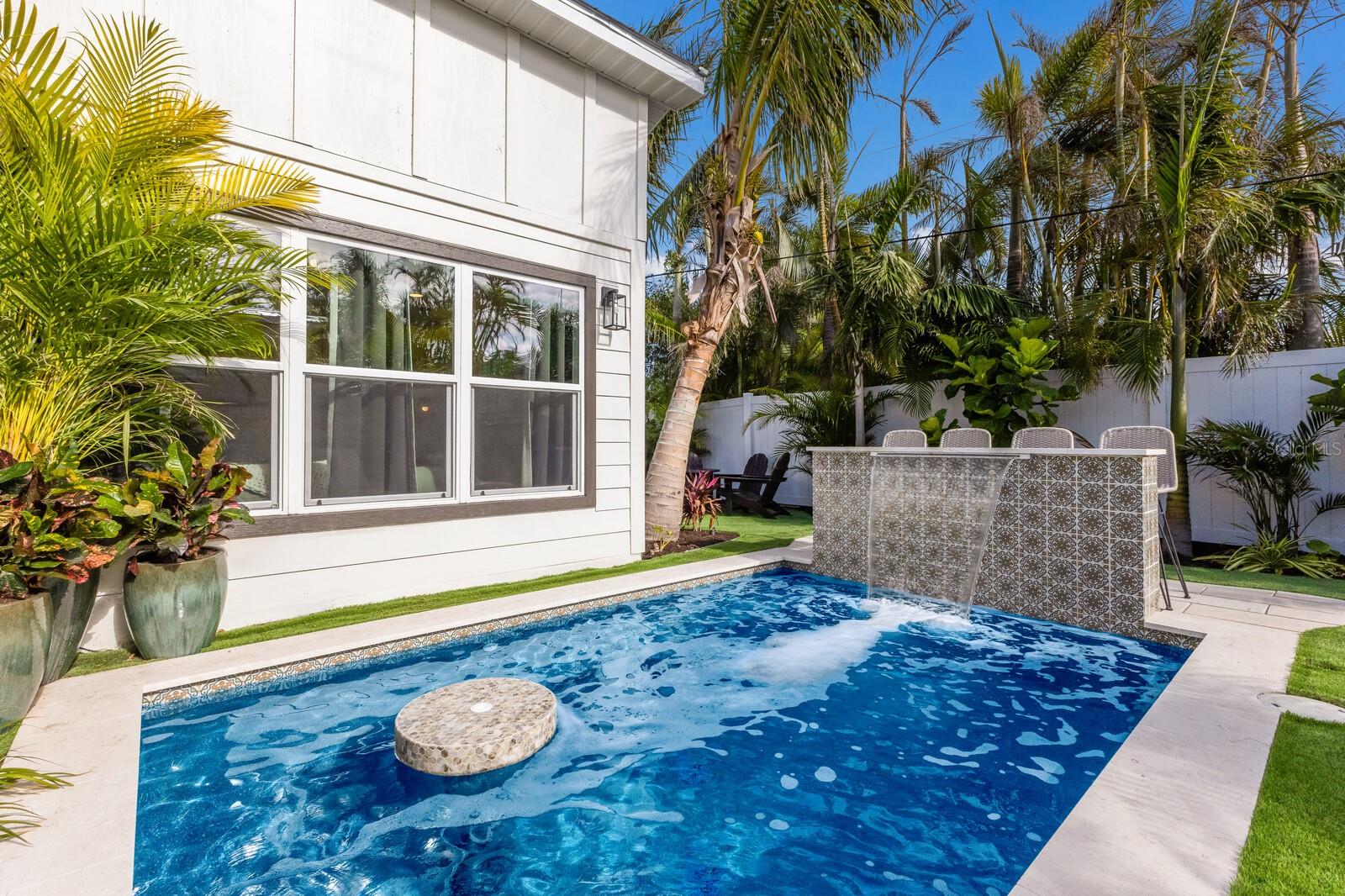 TURNKEY LUXURY WITH VERIFIABLE $85K+ RENTAL INCOME! Welcome to your private piece of paradise at 213 83rd St, East Villa in beautiful Holmes Beach. Whether you are looking for a high-performing addition to your investment portfolio or a sophisticated second home that pays for itself, this exquisite 2/2 villa delivers on every level.  Extensively updated with a modern, coastal chic aesthetic, the home features a gorgeous gourmet kitchen, pristine bathrooms, durable impact-resistant glass, and a rare private garage. The true showstopper is the private backyard oasis—a lush, tropical retreat featuring a sparkling heated pool anchored by a custom waterfall bar that creates an unforgettable island vibe.  Sold fully furnished (turnkey) and beautifully styled, this property bypasses the hassle of setup and steps directly into immediate cash flow. Located a short stroll from the Gulf of Mexico's white sands, this is an unmatched opportunity to own a premium, maintenance-free piece of Anna Maria Island. Financial history available upon request—schedule your tour today!