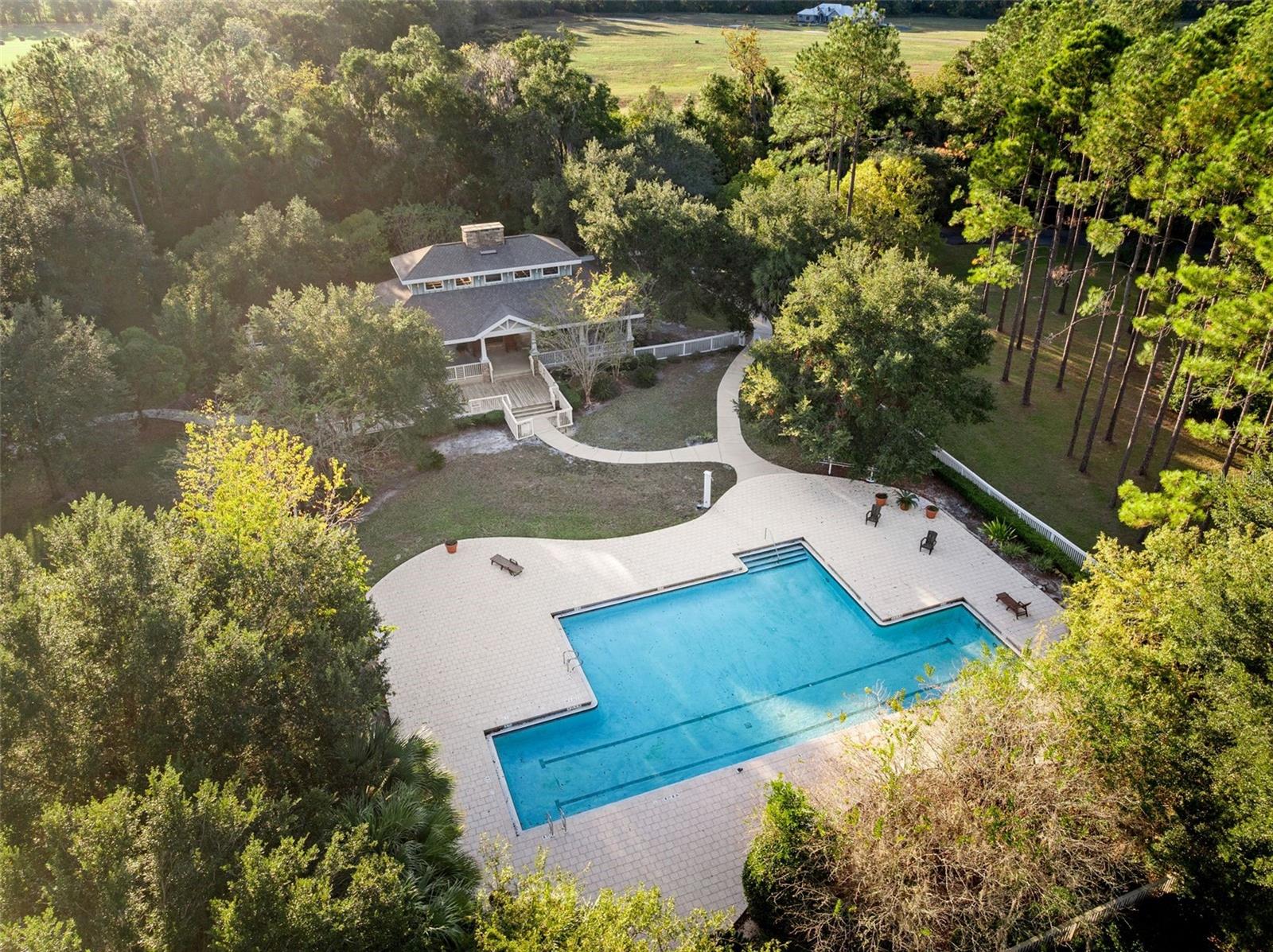 Build your dream home on this beautiful 2.6-acre OPEN-BUILDER lot in the gated luxury community of Dylan’s Grove. Perfectly located across from the community amenities, this rare homesite offers the perfect blend of privacy, nature, and convenience. Enjoy a serene, wooded setting with privacy buffers on both sides and a scenic walking path running alongside the property. As one of the few remaining treed lots in Phase 1, you can select your own canopy and clear only what you choose—creating your ideal private retreat. Dylan’s Grove offers a quiet, upscale lifestyle in SW Alachua County, just minutes from Tioga Town Center and the Jonesville corridor. Residents enjoy miles of paved jogging trails and The Lodge—a 3,000 sq. ft. open-air pavilion featuring a double-sided stone fireplace, summer kitchen, and gathering area. If you’re seeking the perfect lot to build your dream home among grand oaks and tranquil surroundings, look no further—this one-of-a-kind property in Dylan’s Grove is truly special.