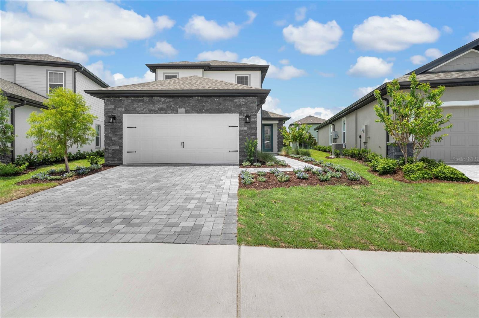 Welcome to the Verona, a beautifully designed 5-bedroom, 3.5-bath home that combines modern sophistication with everyday functionality. Every detail of this residence has been thoughtfully crafted to create a warm, inviting atmosphere perfect for both relaxation and entertaining. The open-concept kitchen is the heart of the home, featuring energy-efficient appliances, elegant countertops, and generous cabinetry that make meal preparation effortless. Flowing seamlessly into the dining and living areas, this layout is ideal for hosting gatherings or spending quality time with family. The master retreat, conveniently located on the first floor, offers a private sanctuary complete with a spa-inspired ensuite bathroom and spacious walk-in closet. Upstairs, you’ll find a collection of comfortable bedrooms and an incredible entertainment room, perfect for movie nights, gaming, or creating your dream media space. Step outside to enjoy a large outdoor patio, ideal for alfresco dining, morning coffee, or evening relaxation under the stars. Verona delivers a perfect balance of style, comfort, and energy efficiency, crafted for the way you live today.