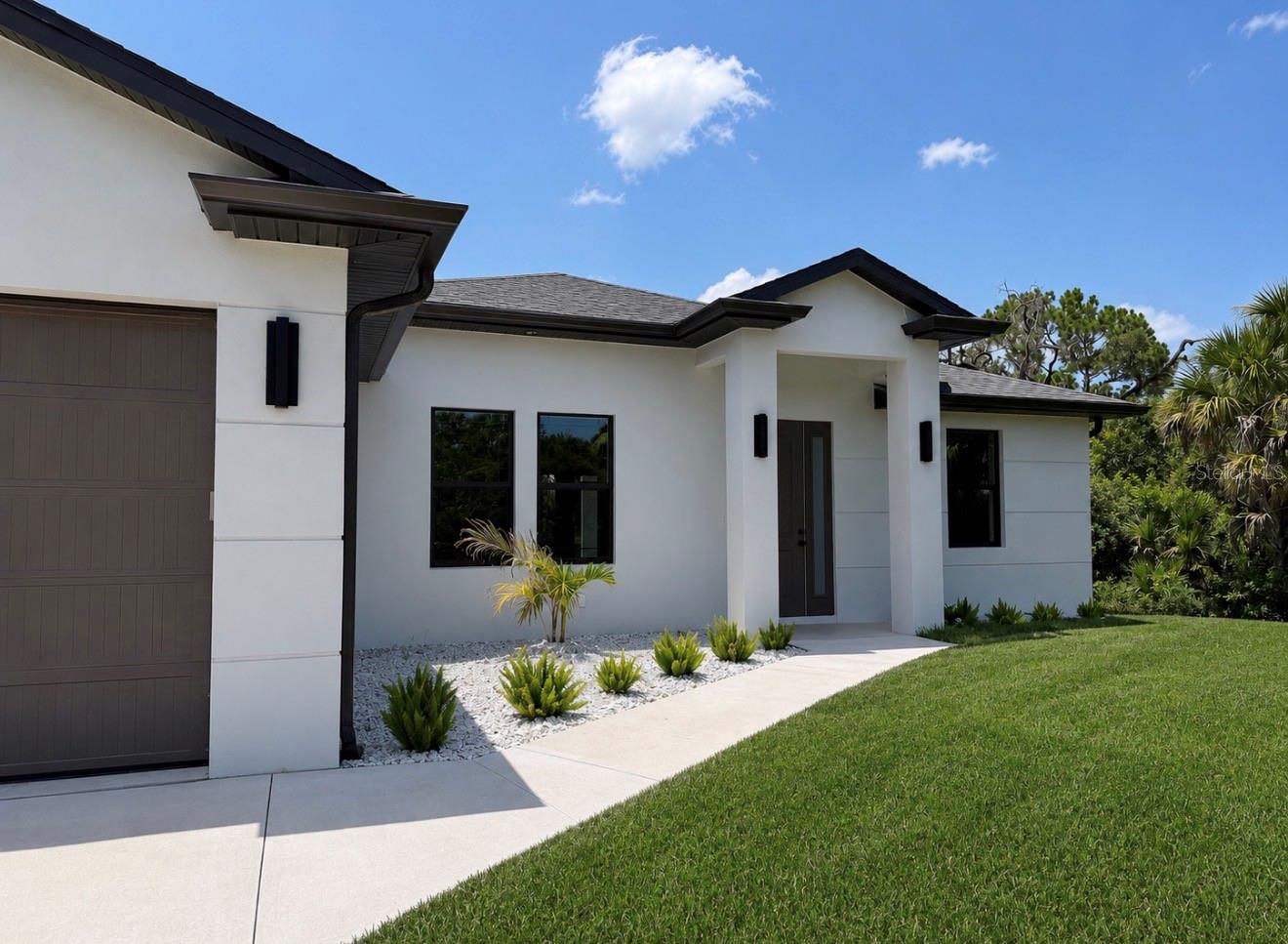 Virtually Staged. BRAND NEW CUSTOM BUILT HOME meticulously crafted to the latest building codes and is MOVE IN READY! NOT IN A FLOOD ZONE (X) Over 2,220 total square feet is ready for you to enjoy Florida Lifestyle. Open concept floor plan, featuring 3 Bedrooms, 2 Bathrooms, 2 car garage, and beautiful porch/lanai. This home is equipped with many upgrades - IMPACT WINDOWS AND DOORS, WATERPROOF LUXURY VINYL FLOORS, Chef's dream KITCHEN EQUIPPED WITH TALL DOUBLE-STACKED SOFT-CLOSE CABINETS, QUARTS COUNTERTOPS, TILE BACKSPLASH, PROFESSIONAL-GRADE APPLIANCES, and a LARGE CENTER ISLAND. Light and airy color combination throughout, infusing the home with an atmosphere of effortless elegance and tranquility. Soaring high ceilings, accentuated by a TRAY CEILING IN THE MASTER BEDROOM while CEILING FANS provide gentle breezes in every room. A spacious INSIDE LAUNDRY ROOM complete with WALL CABINETS, adds convenience to daily living. Custom interior doors, and tall baseboards frame the home with sophistication. Master suite includes 2-WALK IN CLOSETS, DOUBLE VANITY, BEAUTIFUL WALK-IN SHOWER. Great size backyard with plenty of room for your POOL! Gorgeous color combination throughout the home. Located in a desirable location in the growing City of North Port - yet very close to Port Charlotte! Minutes away from World Famous Mineral Springs, North Port's Aquatic Center, Schools, Shopping's and Dining's. Short Drive away from Beautiful Sandy Beaches. Don't wait, schedule your private showing today!