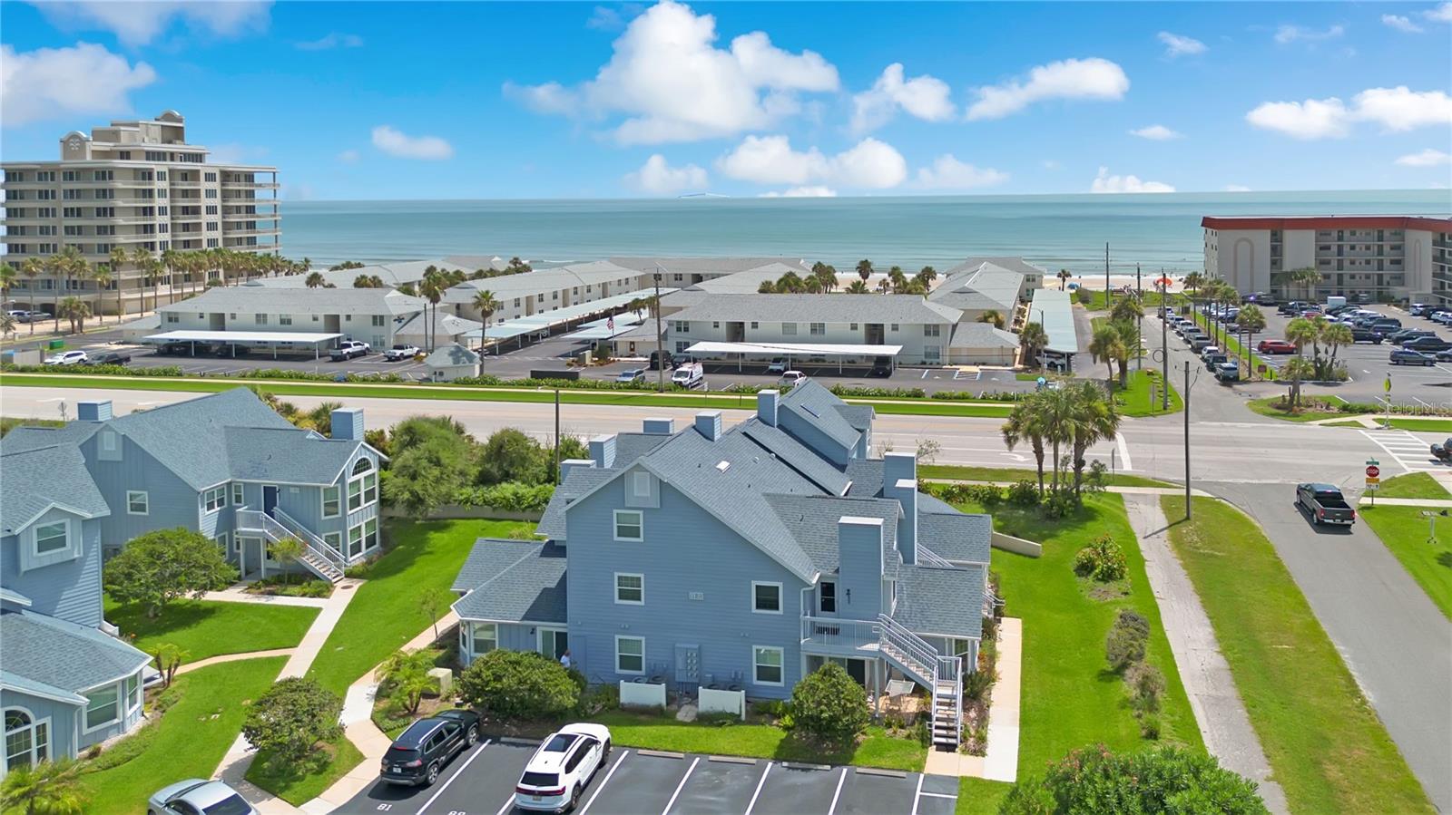 Good luck finding a better value on the island than this charming Sun Beach Club 2/2 just steps from the tranquil shores of New Smyrna’s NO-DRIVE Beach and so close to the sand you can even see the ocean from outside the front door or primary bedroom window.  What a find & location!!  An active(or relaxing) beach-lovers lifestyle awaits, conveniently located directly across the street from the Oyster Quay beach access and a short walk to several dining and shopping options(including Nautilus fitness center) right next door at the Ocean Village Shopping Center.  Sun Beach Club has one of the lowest monthly HOA fees at $477/mo(which includes cable & internet) of any condo community beachside NSB and features a heated pool(seasonally), hot tub and lanai area for its' owners and guests all surrounded by beautifully landscaped grounds.  Recent renovations include all new LVP flooring in both bedrooms and main living area, new baseboards/trim, new plumbing fixtures, new interior doors, new paint, new light fixtures, ceiling fans & more.  The furnishings and decor(ALL INCLUDED WITH SALE) envoke a classic, coastal charm that works beautifully to create the perfect beach home, weekend getaway or investment opportunity you and/or your guests surely will enjoy for years to come.  This building and condo underwent extensive exterior renovations(2023) replacing stucco with concrete board siding giving greater peace of mind your protected from potential storms.  Hurricane impact windows throughout and a roof replaced in 2019 will add even greater security, comfort and savings on insurance and utility bills as well.  The work is done here; just kick back, relax and enjoy the lifestyle you’ve been dreaming of….ALL at such a reasonable price point.  Paradise awaits!!!  Don’t miss this one!!