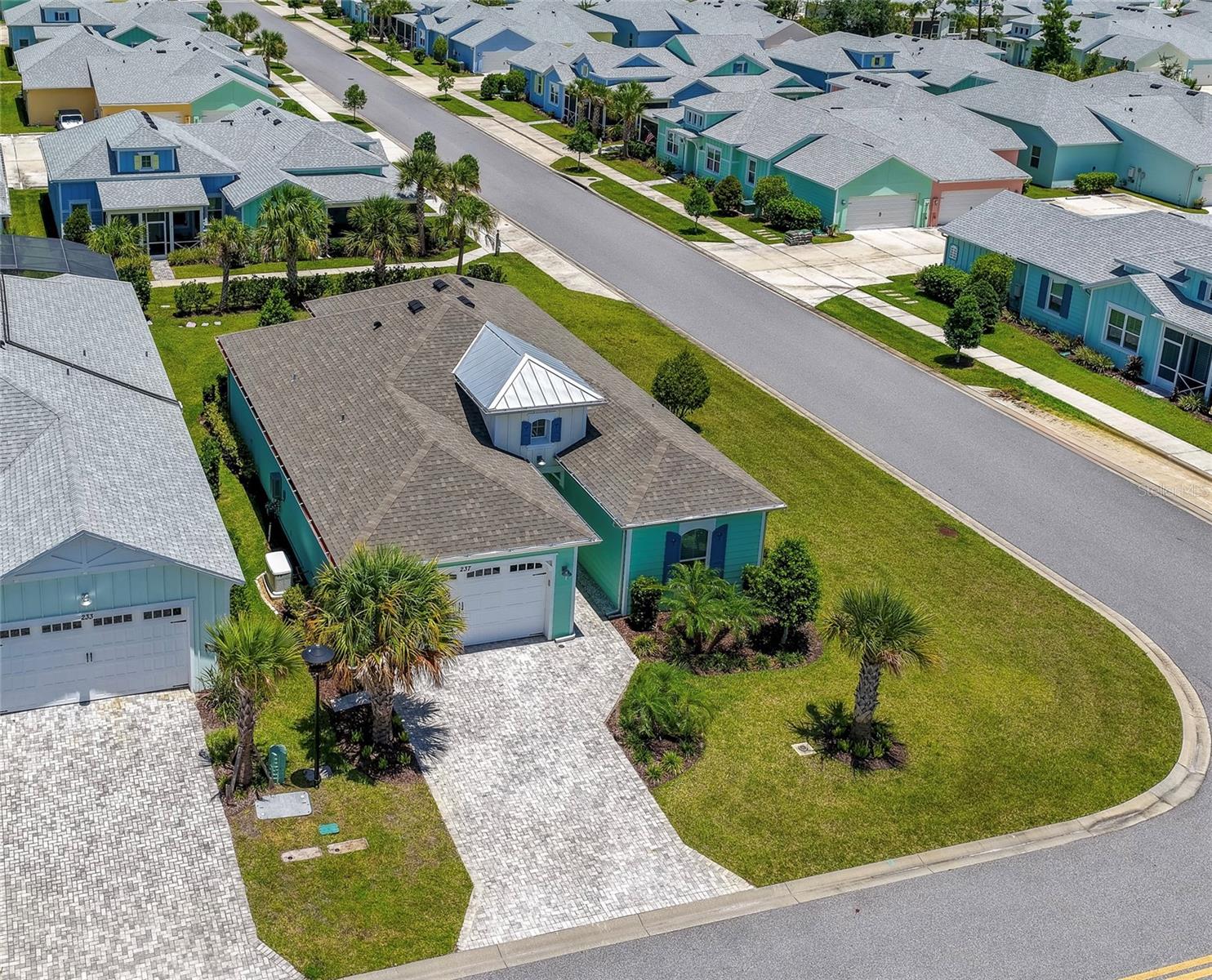 Virtually Staged. Welcome to your slice of paradise at Latitude Margaritaville Daytona Beach! Experience the ultimate in resort style living, worry free with whole house generator and gated access. This beautifully appointed 2-bedroom, 2-bathroom single family home with a private office/flex room or third bedroom is situated on a premium oversized corner lot. Inside, the home is loaded with premium upgrades, including luxury vinyl plank flooring, elegant crown molding in the main living areas, and custom plantation shutters throughout. See attached document of upgrades. A welcoming foyer with soaring ceilings introduces an open-concept floor plan. The expansive great room is filled with natural light and opens seamlessly through oversized sliding glass doors to the screened lanai, creating an inviting setting for everyday living and entertaining. Designed with both style and functionality in mind, the gourmet kitchen serves as the heart of the home. An oversized center island anchors the space, complemented by granite countertops, abundant cabinetry with soft-close drawers and pull-out shelving in both the lower cabinets and the pantry, under-cabinet lighting, premium stainless steel appliances, and a brand-new refrigerator. The adjacent dining area is framed by large windows with plantation shutters, providing an elegant backdrop for casual meals and special occasions alike. The private primary suite offers a relaxing retreat with a tray ceiling and a large walk-in closet. The spa-inspired ensuite features a dual-sink vanity with granite countertop, abundant cabinetry, a linen tower, and an oversized frameless glass walk-in shower. Pocket doors provide privacy for the guest suite and a beautifully finished guest bath with a tiled walk-in shower, and a dedicated office provide flexible living spaces that easily accommodate guests, hobbies, or remote work. Step outside to the expansive screened lanai with paver flooring and a ceiling fan, offering a peaceful place to enjoy Florida's year-round climate. Every detail of this home reflects pride of ownership, including decorative exterior and landscape lighting, a sealed paver driveway, and an oversized two-car garage with a utility sink. The attic is equipped with a fan and additional insulation to help improve energy efficiency and reduce utility costs. For added peace of mind, the whole-house Generac backup generator is regularly serviced and up to date. Experience resort-style living with an array of amenities including a private restaurant / bar, a beach club with shuttle, multiple swimming pools, fitness center with lap pool, tennis, pickleball, a bandshell and scenic walking and hiking trails. Conveniently located with easy access to I-95, you'll be minutes away from world-class beaches, boating and fishing, plus LPGA championship golf, Daytona International Speedway, Tanger Outlet Mall and One Daytona. Don't miss your chance to own this piece of paradise in Latitude Margaritaville Daytona Beach. All information recorded in the MLS is intended to be accurate but cannot be guaranteed.