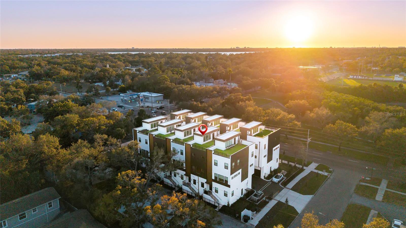 Welcome to Unit 7 at 4th Street Gardens, an exclusive gated community located in the Historic Old Southeast neighborhood, just moments from Downtown St. Petersburg. This beautifully designed townhome offers the perfect combination of modern luxury, convenience, and an unbeatable location. Fully completed, this residence features approximately 2,280 square feet of living space across three levels, plus an impressive nearly 1,000-square-foot rooftop terrace ideal for entertaining, relaxing, or taking in breathtaking sunrise and sunset views of the city skyline. Inside, you'll find a contemporary kitchen, soaring ceilings, three spacious en-suite bedrooms, a spa-inspired primary suite, a private fenced yard, and an oversized garage with 16-foot ceilings. Built with elevated high-and-dry construction, the property did not experience flooding during recent storms. Conveniently located just minutes from the university, Bayfront Hospital, Central Avenue's restaurants and entertainment, waterfront parks, kayaking, and everything Downtown St. Petersburg has to enjoy , Unit 7 is an exceptional opportunity to own a luxury townhome in one of the city's most sought-after neighborhoods.