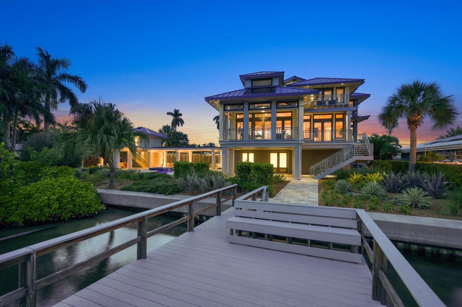 AWARD-WINNING ENERGY EFFICIENT HOME IS HERE!!  This home was designed and built as a one-of-a-kind luxury home equipped for eco-conscious living with a minimal carbon footprint. This stunning Euro-modern designed waterfront home was built with sustainability as a priority without sparing aesthetics or luxury.  This home won HOME OF THE YEAR at the Florida Green Builders annual event. Every piece of equipment, every appliance, even the European lifestyle was factored into the energy optimization model.  The result was a truly green home that exceeds today’s standards, scoring a -9 HERS rating of energy efficiency. The home is completely sustained on solar power with battery storage, LED lighting throughout, and captured rainwater used for landscape systems.  Extraordinary technology is available at the touch of a button for most features. Materials used to build the home are recycled or locally sourced. In addition, this home is made of steel and concrete, able to withstand threats of gale force winds and water.

The interior was designed by Marilyn Whitney utilizing eco-friendly materials to create an open living space that reflects the intentional green practices of the home. The floor plan is also a Universal design, for all stages of life and mobility – you will find no hallways or thresholds in the flooring.   This unique property, sits majestically on a spacious double lot, boasts 3,215 heated sq ft, including 3 bedrooms and 3.5 baths. The interior showcases a European-style design, harmoniously blending natural woods and concrete flooring, creating a perfect blend of chic and comfort. At the heart of this home lies an open-plan living area, complete with an automated lighting & sound system that enhances the ambiance at the touch of a button. The kitchen is equipped with high-end appliances from Wolf, Miele, and SubZero, ensuring a superior culinary experience, truly a chef's dream.

Outside, the expansive backyard is ready for entertaining with multiple patio areas, complete with a heated/chilled pool, spa, and bath house. It also offers ample space for an outdoor kitchen installation. The dock is ready to install a lift for your boat of choice to head out onto Boca Ciega Bay. Overhangs extend 3 feet to provide shade to all windows, while doors and windows are insulated with impact rated low-e glass and feature "tilt and turn" ventilation options.

Enjoy quiet mornings out on the balcony gazing at the spectacular intracoastal waterways!  Lower the screens to fully enclose the patio to eliminate any pests. Need more water views? Head to the crow’s nest at the home’s highest point to see 360 degrees or take in a captivating sunset from the upper balcony as you enjoy happy hour with a nice glass of merlot. Built intentionally, no detail has been spared in this home’s construction, resulting in a remarkable opportunity for the new owners.  Make the move today, it doesn't get any better than this!