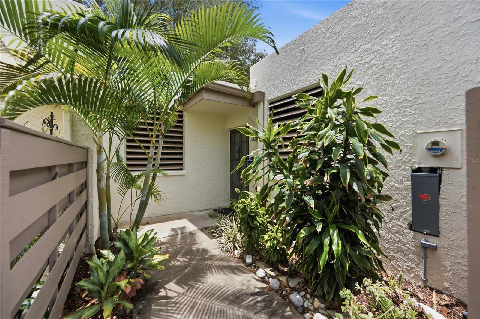 Discover the incredible potential of this rarely available three-bedroom, two-bath, single-story villa in the highly sought-after community of Wildewood Springs. With no one living above you, this residence offers the peace and privacy of villa living along with an inviting floor plan that's ready to be transformed into your dream home. The spacious interior features an updated kitchen, a bright enclosed lanai with new windows installed in 2023, and a private brick-paver patio that provides the perfect setting for morning coffee, outdoor dining, or simply relaxing among the lush tropical surroundings. Major improvements have already been completed, including a new A/C system and electrical panel in 2023, giving you peace of mind while you focus on making the cosmetic updates your own. Wildewood Springs is known for its mature landscaping, winding paths, tranquil ponds, and park-like setting. Residents enjoy a community pool and tennis courts while being just minutes from IMG Academy, championship golf, shopping, restaurants, SRQ Airport, and the beautiful Gulf beaches of Anna Maria Island. Whether you're looking for a full-time residence, seasonal getaway, or investment opportunity, this villa offers the chance to create something truly special in an exceptional location.