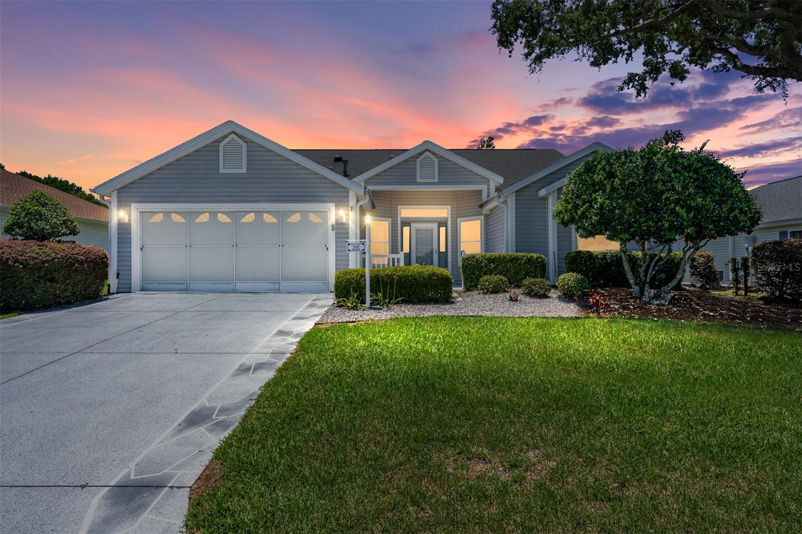 Welcome to this unique Designer Home located in the highly sought-after Village of Valle Verde, ideally located near the vibrant Spanish Springs and Lake Sumter Landing squares, offering convenient access to dining, shopping, and entertainment. Offering 1,979 sq. ft. of air-conditioned space, this beautifully maintained home showcases peaceful views of a private wooded setting and exceptional indoor-outdoor living. A spacious front patio provides the perfect space for relaxing or entertaining guests. Upon entering, you are welcomed by a large foyer. To the right is a comfortable guest bedroom featuring a front-facing window and convenient access to the guest bathroom. Across from the bath is a sizeable storage closet for added functionality. The open-concept floor plan features a spacious living and dining area with sliding glass doors leading directly to the 19 x 19 lanai/birdcage, allowing for abundant natural light and seamless indoor-outdoor enjoyment. A rear den/bonus room, which may also serve as a third bedroom (without a closet), also features sliding door access to the lanai/birdcage and overlooks the tranquil backyard setting. The kitchen offers an eat-in dining area, quartz countertops, ample cabinetry, and all appliances convey with the home. Quartz countertops are also featured throughout the bathrooms, adding a cohesive and upscale touch. The spacious primary suite overlooks the lush wooded area and features private access to the 19 x 19 lanai/birdcage, a large walk-in closet, and an oversized ensuite bathroom. Step outside to enjoy the beautifully landscaped backyard complete with an arbor, Koi pond, waterfall feature, mature plantings, and exceptional privacy. Additional updates include a new HVAC system installed in March 2026 and a roof replaced in Oct. 2022. A golf cart is included with the home, adding convenience and easy access to nearby amenities. Best of all, there is NO BOND! THis home is being sold "AS IS".