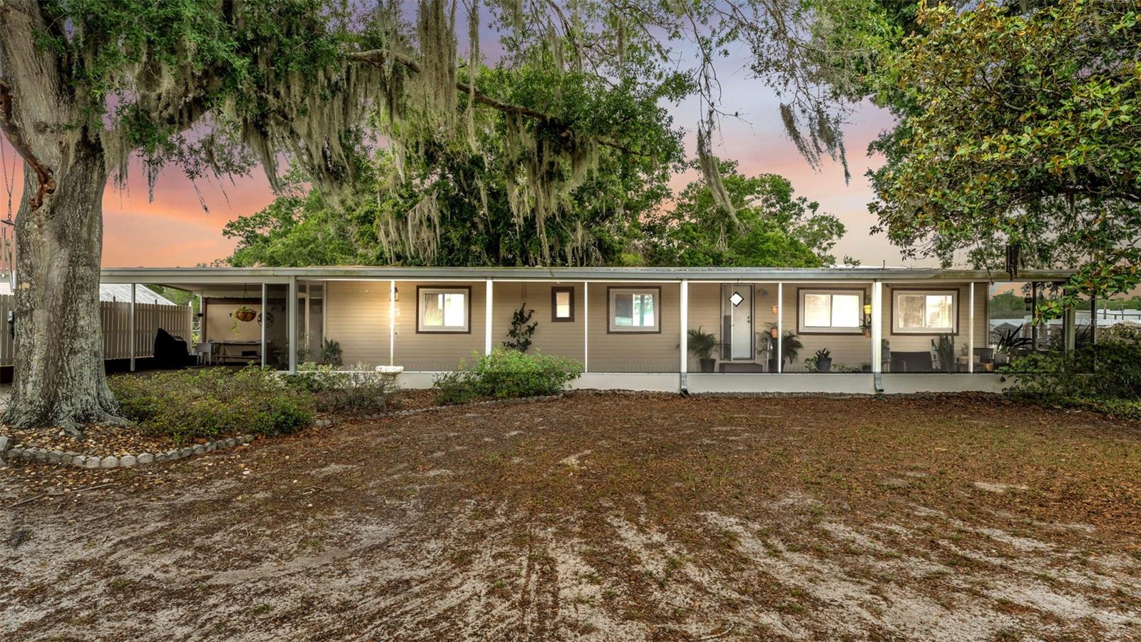 Welcome to 3490 Espo Drive in the peaceful countryside of Mulberry — a beautifully maintained four-bedroom, two-bathroom home situated on an expansive 1.03-acre lot offering the perfect blend of privacy, space, and convenience. Surrounded by mature oak trees that provide incredible shade and a picturesque setting, this property delivers the relaxed Florida lifestyle while still being just a short drive from Lakeland shopping, dining, and entertainment.  As you enter the home, you’ll immediately notice the updated luxury vinyl plank flooring flowing throughout the interior along with fresh interior paint, creating a clean and rustic feel throughout the living spaces. The functional layout offers four spacious bedrooms and two bathrooms designed for comfortable everyday living.  The kitchen connects to the large dining/living room that creates a perfect space for family and friends.  Stepping outside, the property truly shines with endless opportunities for entertaining and enjoying the outdoors. The oversized fenced backyard features a custom-built fire pit area perfect for gatherings, while the large 1.03-acre lot provides plenty of room for pets, recreation, and future possibilities. A storage shed offers additional space for tools and equipment, and the oversized two-vehicle carport provides covered parking and convenience.  If you’ve been searching for a property with space, privacy, shade-filled outdoor living, and easy access to both Mulberry and Lakeland, this home is a must-see.