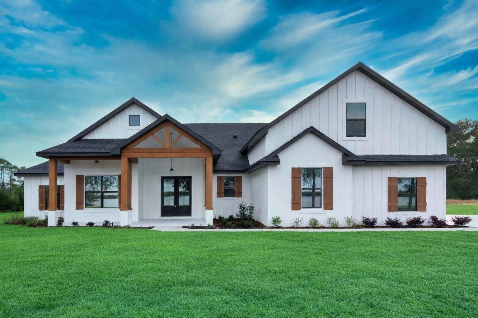 Pre-Construction. To be built. The stunning MODERN FARMHOUSE offers 2,498 sq ft of beautifully curated living space, designed with both comfort and style in mind. This thoughtfully planned layout includes 3 bedrooms, 3.5 baths, flex space. Throughout the home, you’ll find soaring 10-foot ceilings, detailed crown molding, and upgraded baseboards that enhance the elevated, custom feel Kevco is known for.
Enjoy true lakefront living with approximately 117 feet of frontage on South Twin Lake in Umatilla—an ideal setting for peaceful mornings, sunset views, and the relaxed Florida lifestyle.
The open-concept design centers around a gorgeous designer kitchen featuring quartz countertops, upgraded cabinetry, warm wood accents, a generous island, and stylish lighting. Wood-look flooring, shiplap details, and premium finishes flow seamlessly from room to room. The primary suite feels like a private retreat, offering a spa-inspired bath with a freestanding tub, walk-in shower with decorative tile inlay, dual vanities, and a spacious walk-in closet.
This is a fantastic opportunity to build with Kevco and select YOUR own custom finishes and design options, ensuring the home reflects your personal style.
Quality construction includes energy-efficient features, double-pane windows, premium trim work, and Kevco’s signature craftsmanship. As Lake County’s most award-winning and trusted custom home builder—with over 40 years of innovation, integrity, and excellence—Kevco continues to deliver exceptional value and enduring quality.
Enjoy peaceful lake views, an optional HOA, and the rare combination of new construction, acreage, and waterfront living—all just minutes from Umatilla, Eustis, and Mount Dora.