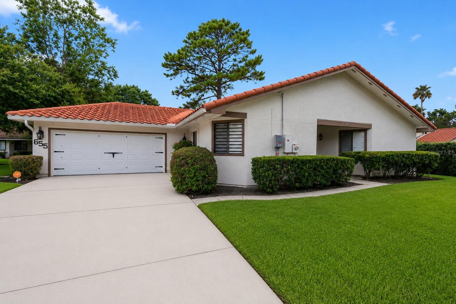 Welcome home to this impeccably maintained 2-bedroom, 2-bath home in the highly desirable area of Winter Springs, Florida!  From the moment you step inside, you'll appreciate the open floor plan, soaring vaulted ceilings, and spacious living area centered around a stunning wood-burning fireplace—creating the perfect setting for both relaxing evenings and entertaining guests. The heart of the home is the completely remodeled kitchen (2024), featuring timeless Shaker cabinetry, beautiful butcher-block countertops, an oversized undermount sink, under-cabinet LED accent lighting, and a full suite of high-end stainless-steel appliances. The adjacent pass-through adds both convenience and connectivity, making entertaining effortless. Both bedrooms are generously sized, offering comfortable retreats with ample flexibility to suit your lifestyle. Whether you're hosting overnight guests, creating a dedicated home office, or simply enjoying extra space to unwind, these well-appointed rooms provide endless possibilities. The impressive updates continue with a fully remodeled bathroom (2024), new flooring throughout (2023), a new 40-year clay tile roof (2023), and a new garage door (2022), providing peace of mind for years to come.  Outside is a well-kept backyard featuring a generously sized patio with a partially covered seating area—ideal for year-round outdoor dining, entertaining, or simply relaxing with your morning coffee or evening beverage. The low-maintenance outdoor space offers plenty of room to enjoy as-is while still providing endless possibilities for personalization and for creating your own backyard retreat.  Ideally located near shopping, dining, parks, and recreation, this home also offers easy access to SR 417 and I-4 for a convenient commute. Situated within an A-rated school district and a community with fantastic amenities, this exceptional home offers the perfect combination of style, comfort, convenience, and pride of ownership.  Don't miss your opportunity to make this beautifully updated, truly turnkey home your own!  Schedule your showing today as this wont last long.