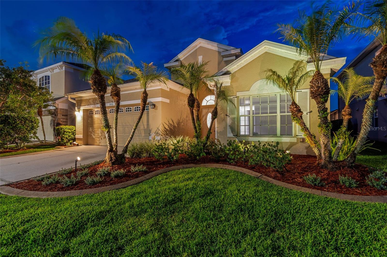Absolutely idyllic location now available in the popular gated golf cart community of Plantation Palms in Land O Lakes! Situated on a peaceful cul-de-sac and just off the 7th hole of the golf course, this single story 3-bedroom, 2-bath, 2-car garage home features lovely mature landscaping and gorgeous pond views including breathtaking sunsets. Sit back and relax in your beautiful screened-in oversized lanai, complete with stone pavers and ceiling fans, while enjoying the various birds, deer, and other wildlife that grace this tranquil location. The home itself boasts an open floor plan making it easy to entertain with its spacious living area and beautiful open kitchen space. The updated kitchen includes a breakfast bar, 42-inch wood cabinets, stainless appliances, pantry, and a breakfast nook. You'll appreciate the updated luxury vinyl plank flooring and ceramic tile throughout -- no carpet! The home offers a split floor plan, including the generously sized primary suite which overlooks the golf course/pond and features an updated bathroom, complete with frameless glass shower and garden tub. The inside laundry room includes a newer washer and dryer (2022), and the 2-car garage features storage shelving and a convenient utility sink. Other updates include a newer roof (2023), newer range and dishwasher (2024), and fresh landscaping (2026). Plantation Palms is a highly sought after community that boasts an 18-hole semi-private par-72 golf course, an 11-acre driving range with night lighting, an 18-hole miniature golf course, and a club house which features the very popular Mulligans restaurant/bar which includes a banquet room for special occasions. This home truly has the ideal location -- a mile away from the Land O' Lakes recreation complex & public library and less than 10 minutes from the Tampa Premium Outlets and I-75. Schedule your private showing today!