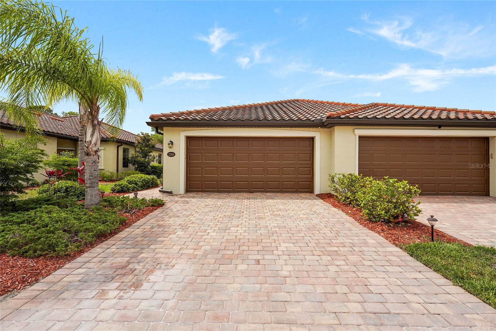 Welcome to this beautifully maintained villa nestled within the highly sought after Gran Paradiso in Venice. Framed by majestic palm trees and lush tropical landscaping, this elegant residence captures the essence of relaxed Florida living while offering the perfect blend of luxury, comfort, and convenience. Offered fully furnished, this move in ready home allows you to begin enjoying the Florida lifestyle immediately. Designed with modern living in mind, the villa features a bright open floor plan filled with natural light from oversized windows and sliding glass doors. The spacious living and dining areas flow seamlessly into a stylish kitchen appointed with granite countertops, quality appliances, abundant cabinetry, and generous prep space, ideal for both everyday living and entertaining. In addition to the two spacious bedrooms, the home also features a versatile office/den space that can easily be converted into a third bedroom, guest room, or private study, offering flexibility to suit a variety of lifestyles and needs. All bedrooms and the office space are comfortably carpeted, creating a warm and inviting atmosphere throughout the private living areas. The primary suite serves as a private retreat with two closets, direct access to the screened lanai through sliding glass doors, and a beautifully appointed ensuite bathroom featuring dual vanities, a large soaking tub, and an expansive walk in shower with a detachable showerhead. The guest bedroom is generously sized and offers ample space for family and visitors, while the secondary bathroom is tastefully finished with an elegant vanity and a convenient tub and shower combination. From both the living room and the primary suite, step outside to your private screened lanai, an inviting outdoor retreat featuring beautifully finished brick pavers, perfect for enjoying your morning coffee, taking in evening sunsets, or simply relaxing amid the tranquil tropical surroundings. Residents of Gran Paradiso enjoy exceptional resort style amenities, including a luxurious community pool, fitness center, and beautifully maintained walking paths throughout the community. Whether you prefer an active lifestyle or peaceful relaxation, this vibrant gated community offers something for everyone. Ideally situated near the rapidly growing Wellen Park area, residents enjoy convenient access to an exciting mix of restaurants, boutique shopping, cafés, entertainment venues, and community events. The nearby CoolToday Park, spring training home of the Atlanta Braves, hosts year round sporting events, concerts, and local gatherings that add to the area’s vibrant atmosphere. Just a short drive away, Historic Downtown Venice offers charming boutiques, outdoor dining, farmers markets, art festivals, live music, and a welcoming coastal town feel. Venice is also renowned for its stunning Gulf beaches, scenic nature trails, boating, kayaking, fishing, golf courses, and breathtaking sunsets. The area is known for its strong sense of community, excellent healthcare facilities, top rated schools, and convenient access to Interstate 75, making travel to Sarasota, Fort Myers, Tampa, and surrounding areas easy and accessible. Whether you are searching for a seasonal retreat, investment opportunity, or full time residence, this villa presents an outstanding opportunity to experience the resort style lifestyle of Gran Paradiso and the very best of Venice, Florida living.